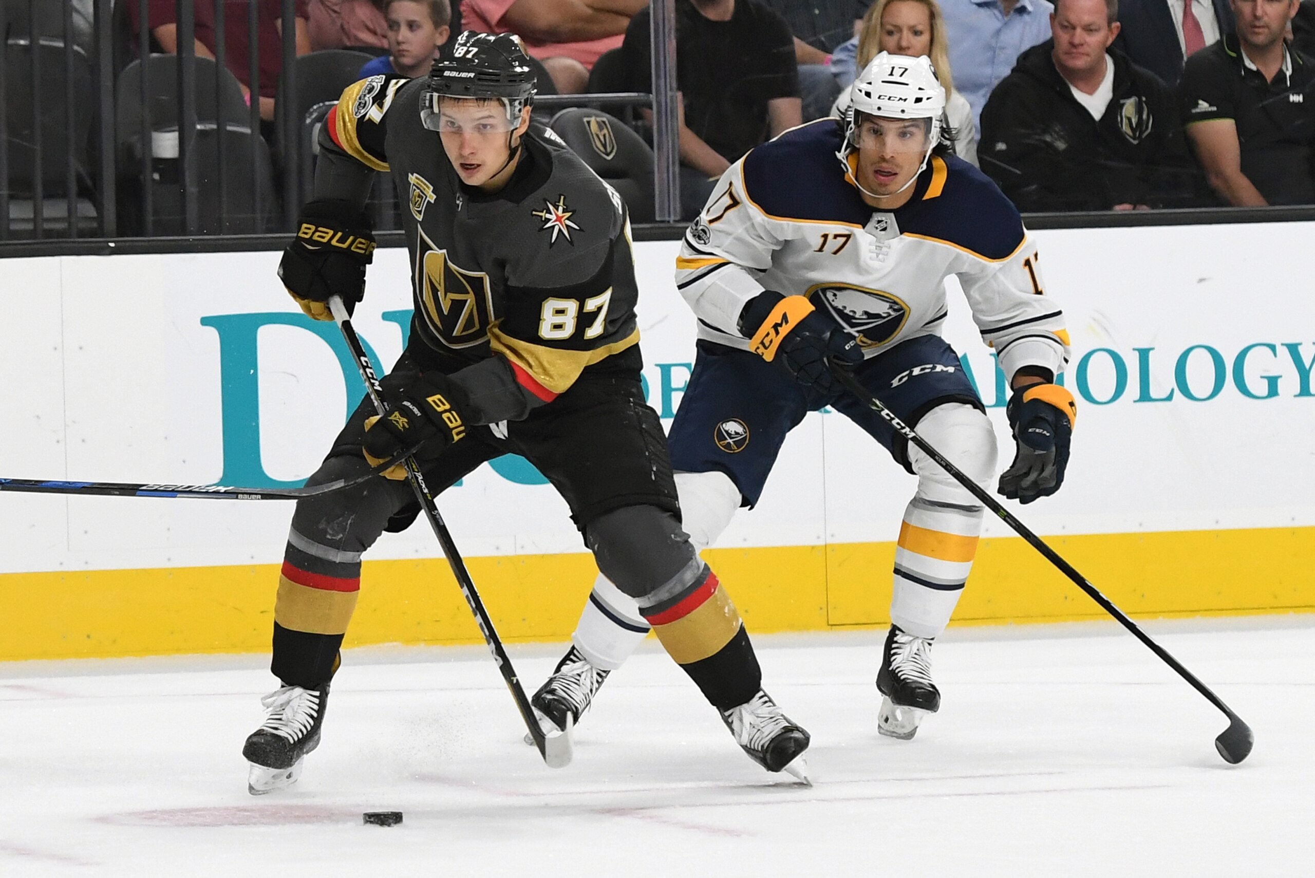 LAS VEGAS, NV - OCTOBER 17:  Vadim Shipachyov #87 of the Vegas Golden Knights skates with the puck ahead of Jordan Nolan #17 of the Buffalo Sabres in the second period of their game at T-Mobile Arena on October 17, 2017 in Las Vegas, Nevada. The Golden Kn