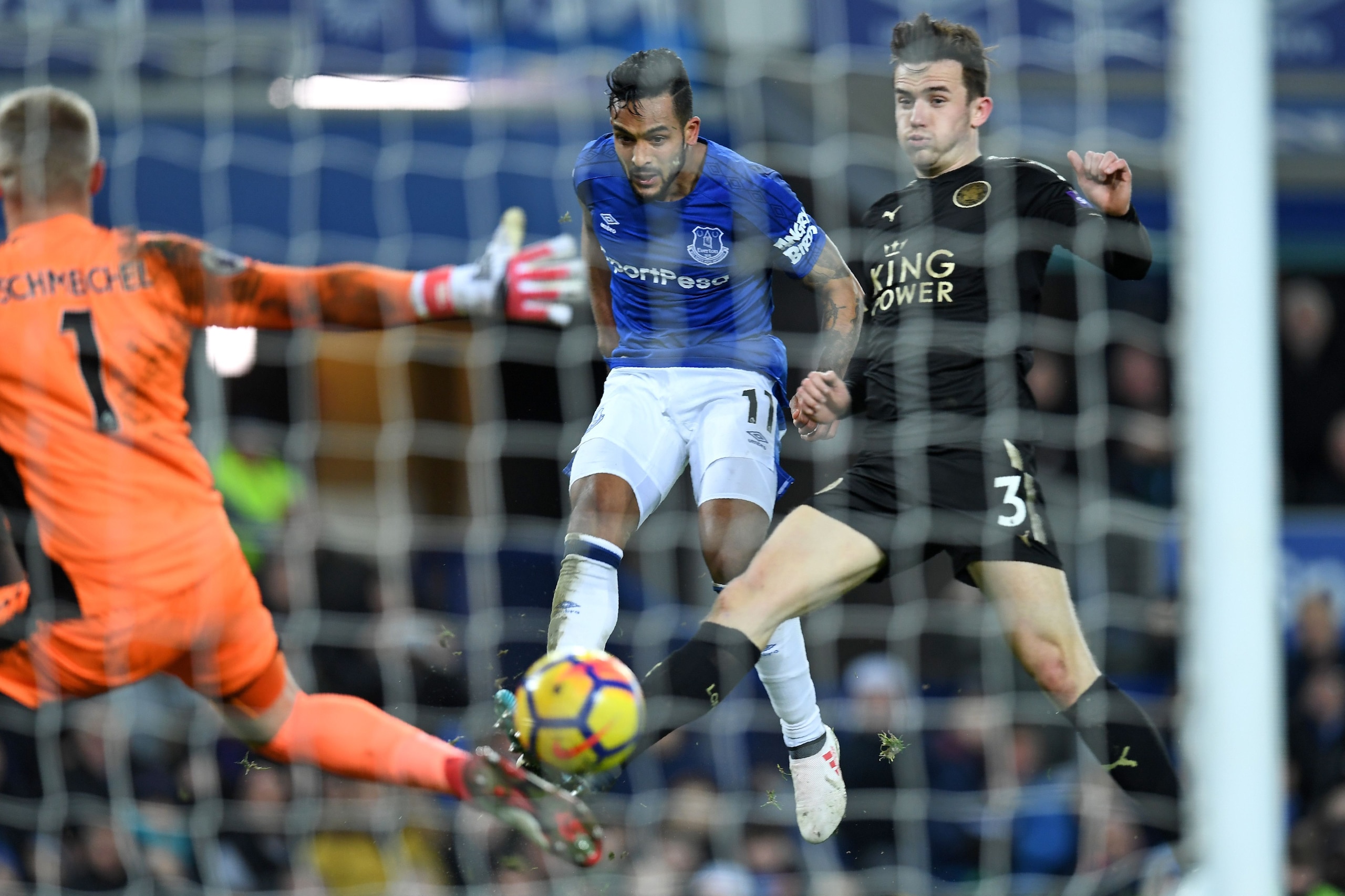 Everton's English striker Theo Walcott (C) shoots past Leicester City's Danish goalkeeper Kasper Schmeichel to score their second goal during the English Premier League football match between Everton and Leicester City at Goodison Park in Liverpool, north