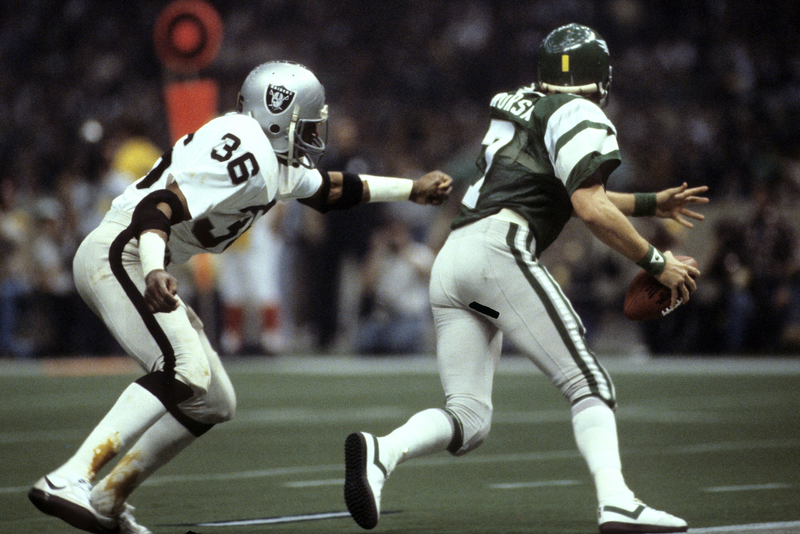 Oakland Raiders safety Mike Davis (36) harasses Philadelphia Eagles quarterback Ron Jaworski (7) during Super Bowl XV, a 27-10 Raiders victory on January 25, 1981, at the Louisiana Superdome in New Orleans, Louisiana. (Photo by Nate Fine/Getty Images)