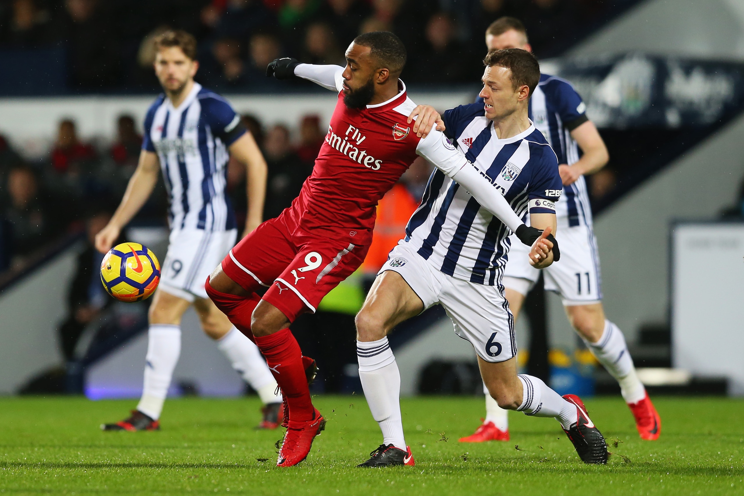 WEST BROMWICH, ENGLAND - DECEMBER 31: Alexandre Lacazette of Arsenal holds off Jonny Evans of West Bromwich Albion during the Premier League match between West Bromwich Albion and Arsenal at The Hawthorns on December 31, 2017 in West Bromwich, England. WEST BROMWICH, ENGLAND - DECEMBER 31: Alexandre Lacazette of Arsenal holds off Jonny Evans of West Bromwich Albion during the Premier League match between West Bromwich Albion and Arsenal at The Hawthorns on December 31, 2017 in West Bromwich, England.