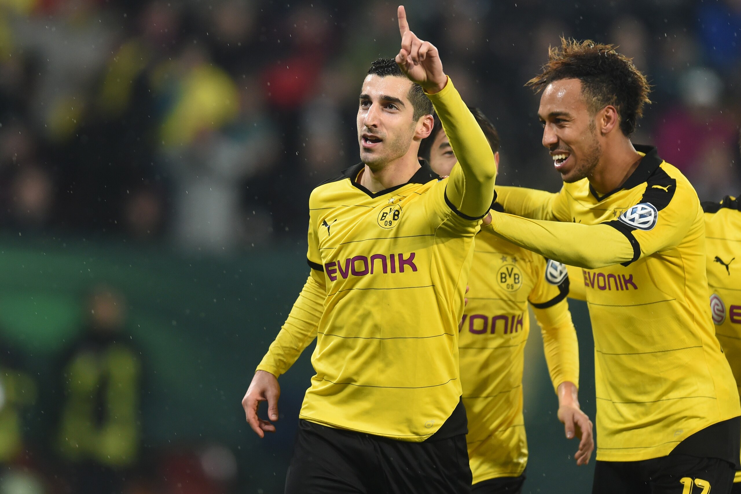 (L-R) Dortmund's Armenian midfielder Henrikh Mkhitaryan, Dortmund's Gabonese striker Pierre-Emerick Aubameyang celebrate after the second goal during the German Cup DFB Pokal third round match between Borussia Dortmund and FC Augsburg in Augsburg on Decem