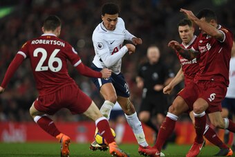 Tottenham Hotspur's English midfielder Dele Alli (C) vies with Liverpool's Scottish defender Andrew Robertson (L) during the English Premier League football match between Liverpool and Tottenham Hotspur at Anfield in Liverpool, north west England on Febru