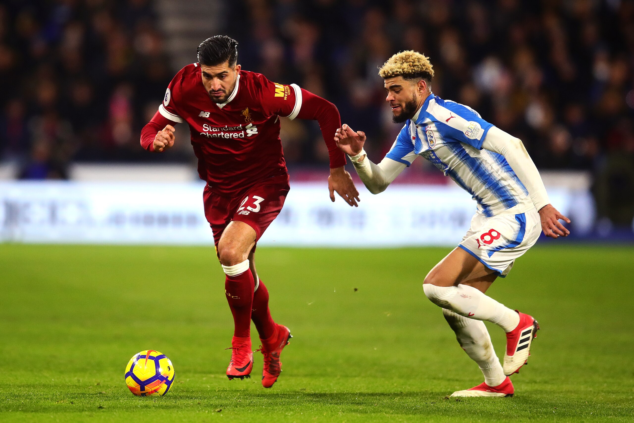 HUDDERSFIELD, ENGLAND - JANUARY 30: Philip Billing of Huddersfield Town in action with Emre Can of Liverpool during the Premier League match between Huddersfield Town and Liverpool at John Smith's Stadium on January 30, 2018 in Huddersfield, England. (Pho