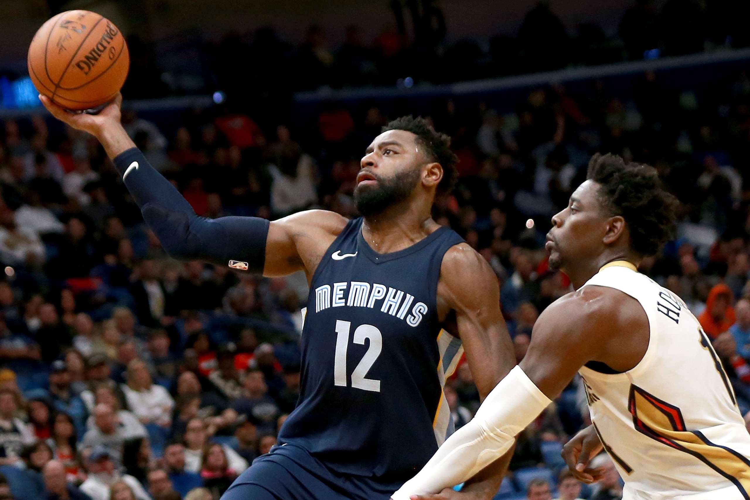 NEW ORLEANS, LA - JANUARY 20:  Tyreke Evans #12 of the Memphis Grizzlies shoots over Jrue Holiday #11 of the New Orleans Pelicans during the second half of a NBA game at the Smoothie King Center on January 20, 2018 in New Orleans, Louisiana. NOTE TO USER: