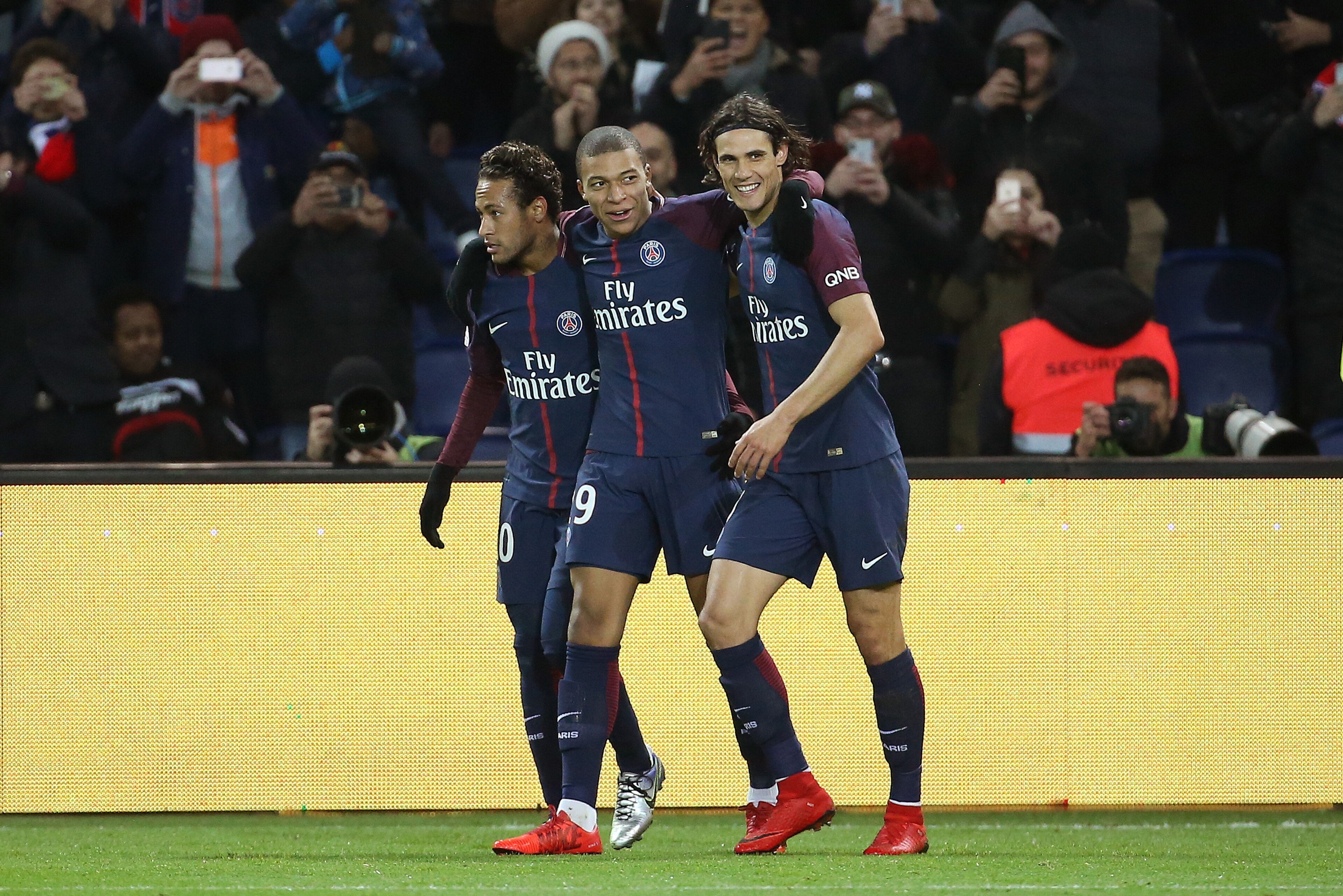 PARIS FRANCE - JANUARY 17: Kylian Mbappe of PSG celebrates his goal between Neymar Jr and Edinson Cavani during the French Ligue 1 match between Paris Saint Germain (PSG) and Dijon FCO at Parc des Princes stadium on January 17, 2018 in Paris, France. (Pho