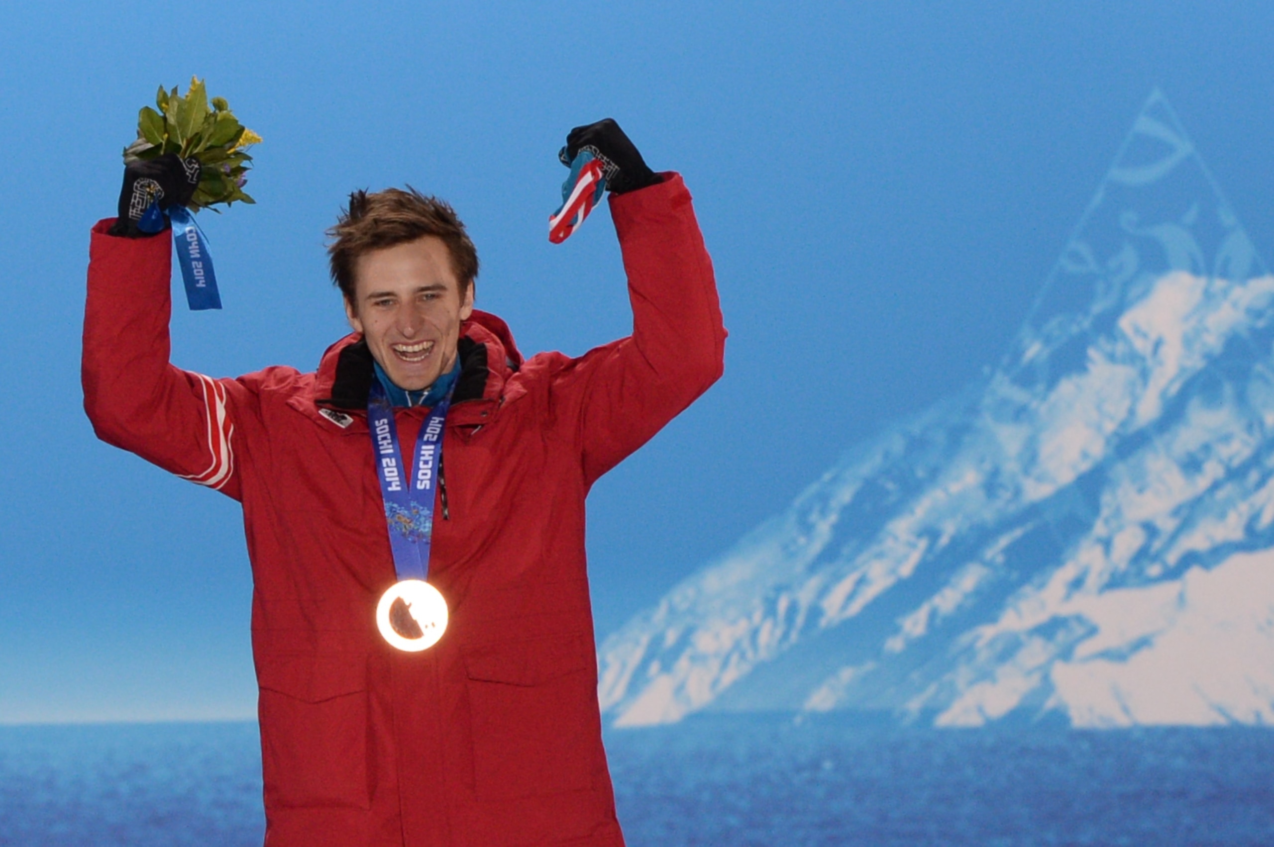 A picture taken with a robotic camera shows Austria's gold medalist Matthias Mayer posing with his medal on the podium during the Men's Alpine Skiing Downhill Medal Ceremony at the Sochi medals plaza during the Sochi Winter Olympics on February 9, 2014.  