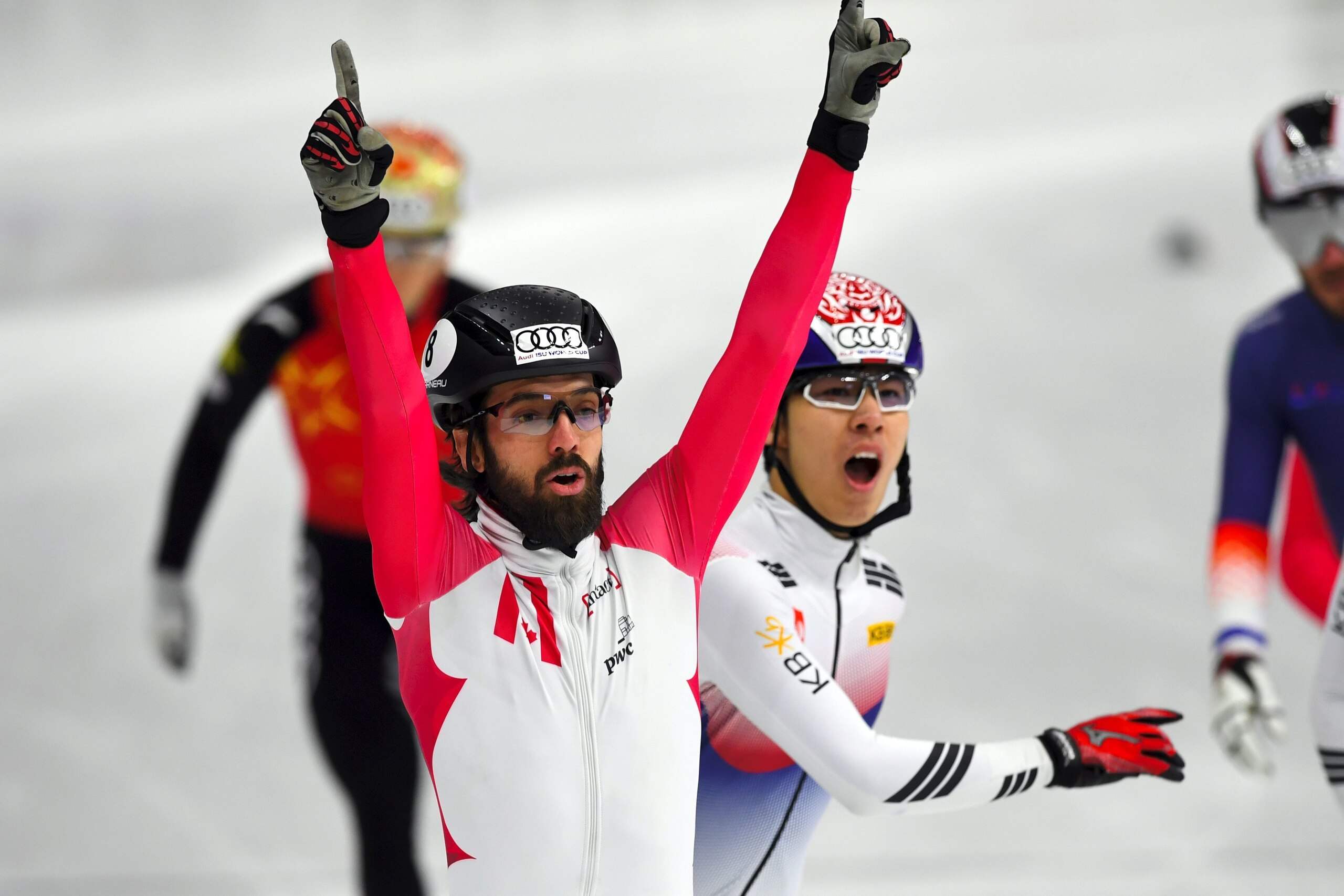 Charles Hamelin (front L) of Canada celebrates his victory as Hwang Dae-Heon (2nd L) of South Korea reacts after the men's 1500m final at the ISU World Cup Short Track Speed Skating in Seoul on November 18, 2017.
 / AFP PHOTO / JUNG Yeon-Je        (Photo 