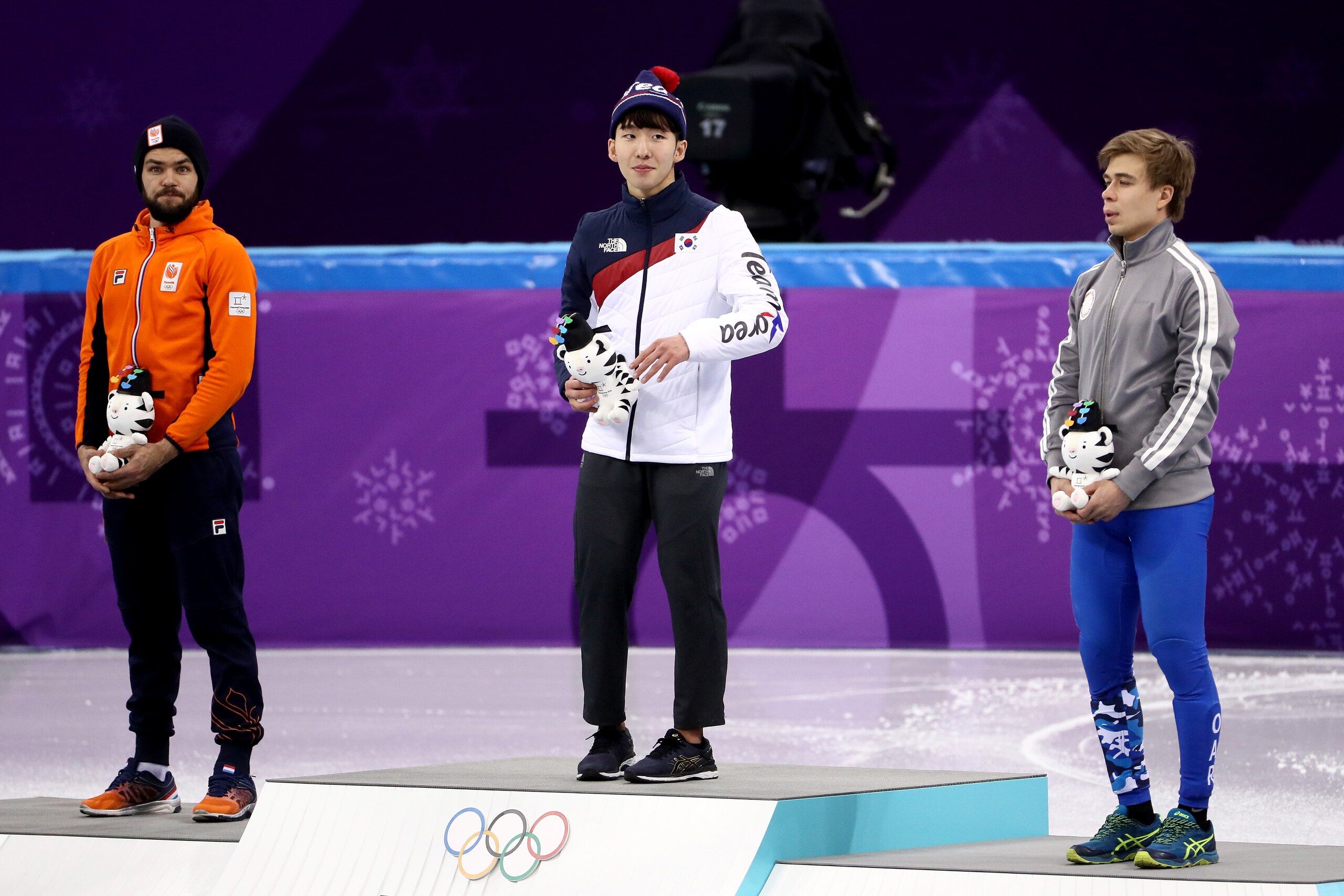 GANGNEUNG, SOUTH KOREA - FEBRUARY 10:  (L-R) Silver medalist Sjinkie Knegt of the Netherlands, gold medalist Hyojun Lim of Korea and bronze medalist Semen Elistratov of Olympic Athlete from Russia are celebrated at the victory ceremony during the Men's 15