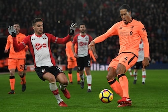 SOUTHAMPTON, ENGLAND - FEBRUARY 11: Virgil van Dijk of Liverpool is put under pressure from Dusan Tadic of Southampton during the Premier League match between Southampton and Liverpool at St Mary's Stadium on February 11, 2018 in Southampton, England.  (P