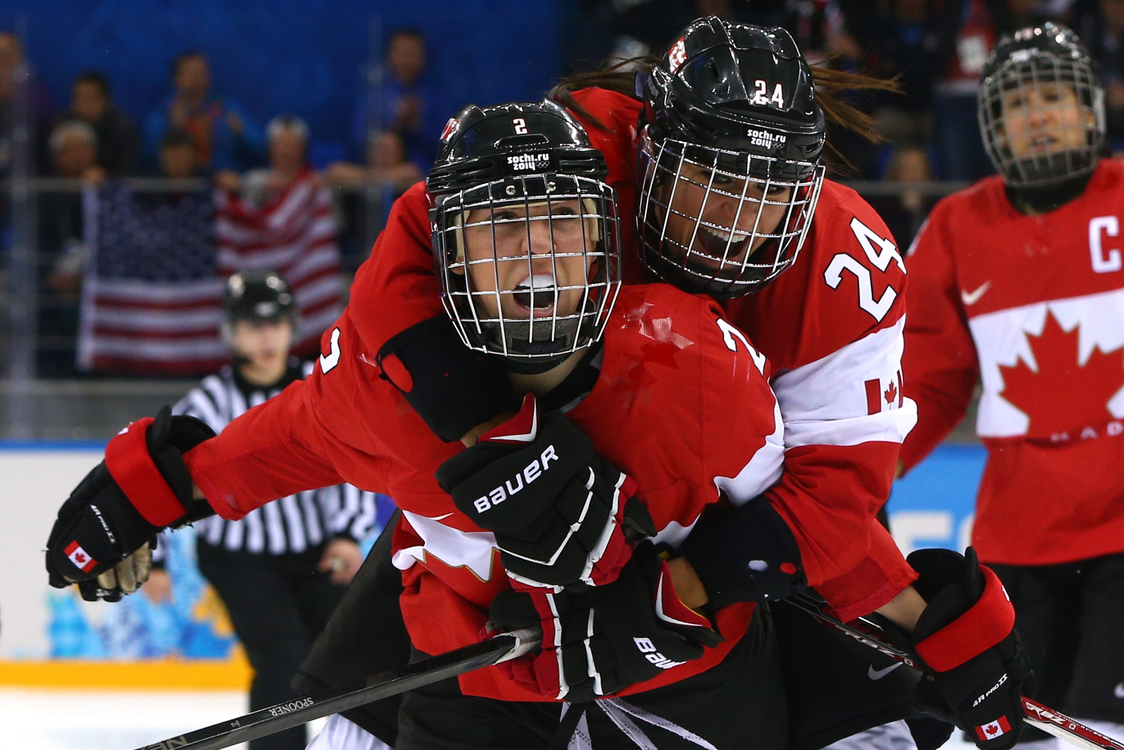 SOCHI, RUSSIA - FEBRUARY 12:  Meghan Agosta-Marciano #2 of Canada celebrates after scoring a goal with Natalie Spooner #24 in the third period against the United States during the Women's Ice Hockey Preliminary Round Group A game on day five of the Sochi 