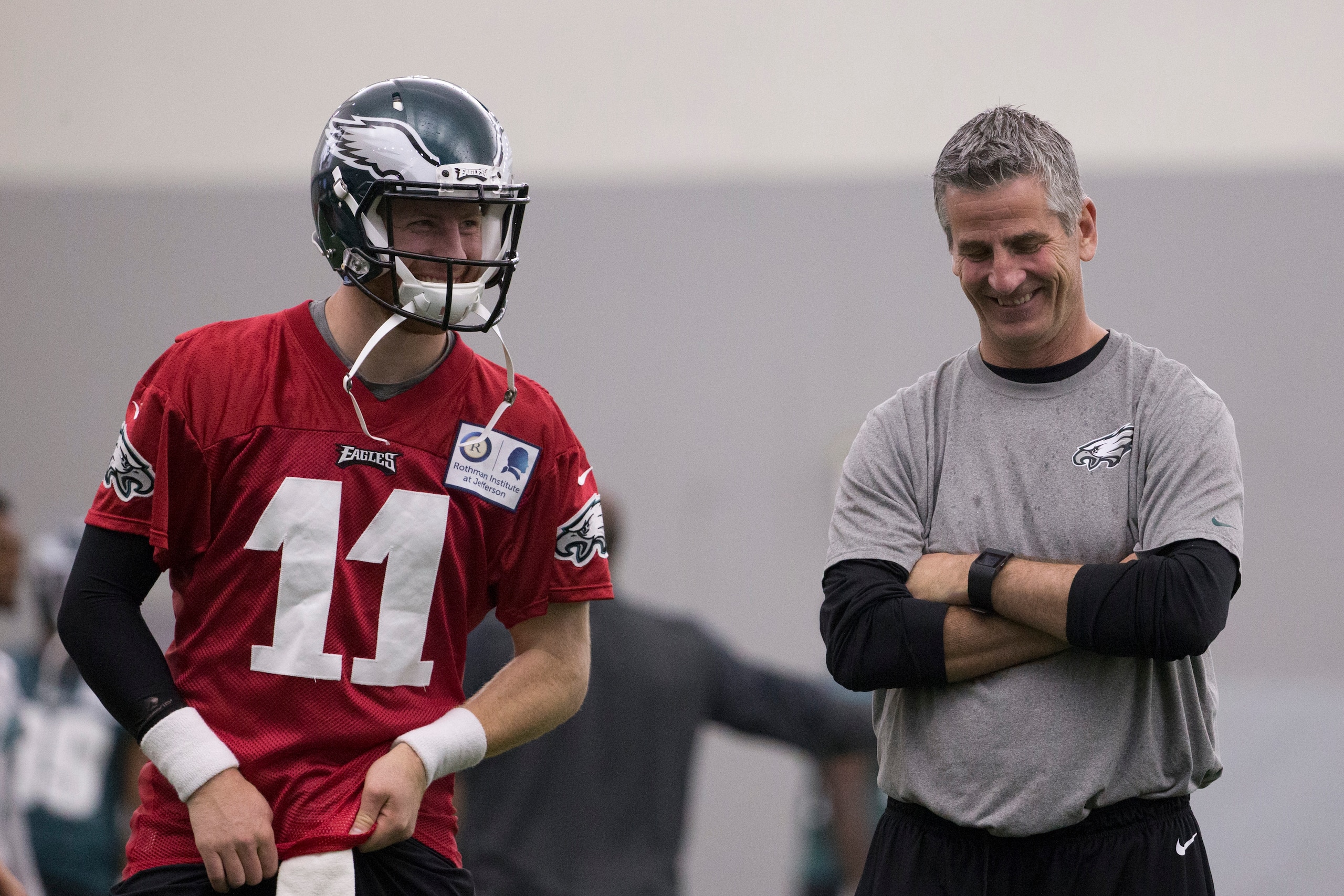 PHILADELPHIA, PA - MAY 13: Carson Wentz #11 of the Philadelphia Eagles talks to offensive coordinator Frank Reich during rookie camp at the NovaCare Complex on May 13, 2016 in Philadelphia, Pennsylvania. (Photo by Mitchell Leff/Getty Images)