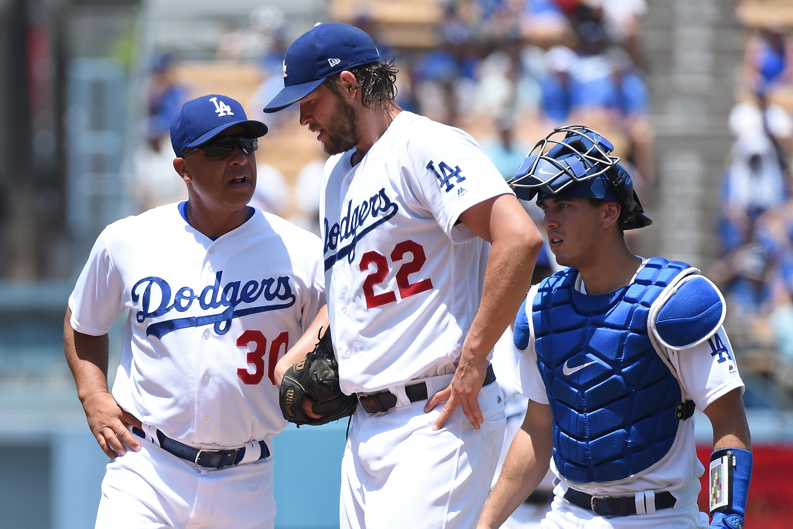 LOS ANGELES, CA - JULY 23:  Clayton Kershaw #22 of the Los Angeles Dodgers is checked for a possible injury in the second inning against the Atlanta Braves at Dodger Stadium on July 23, 2017 in Los Angeles, California.  (Photo by Lisa Blumenfeld/Getty Ima
