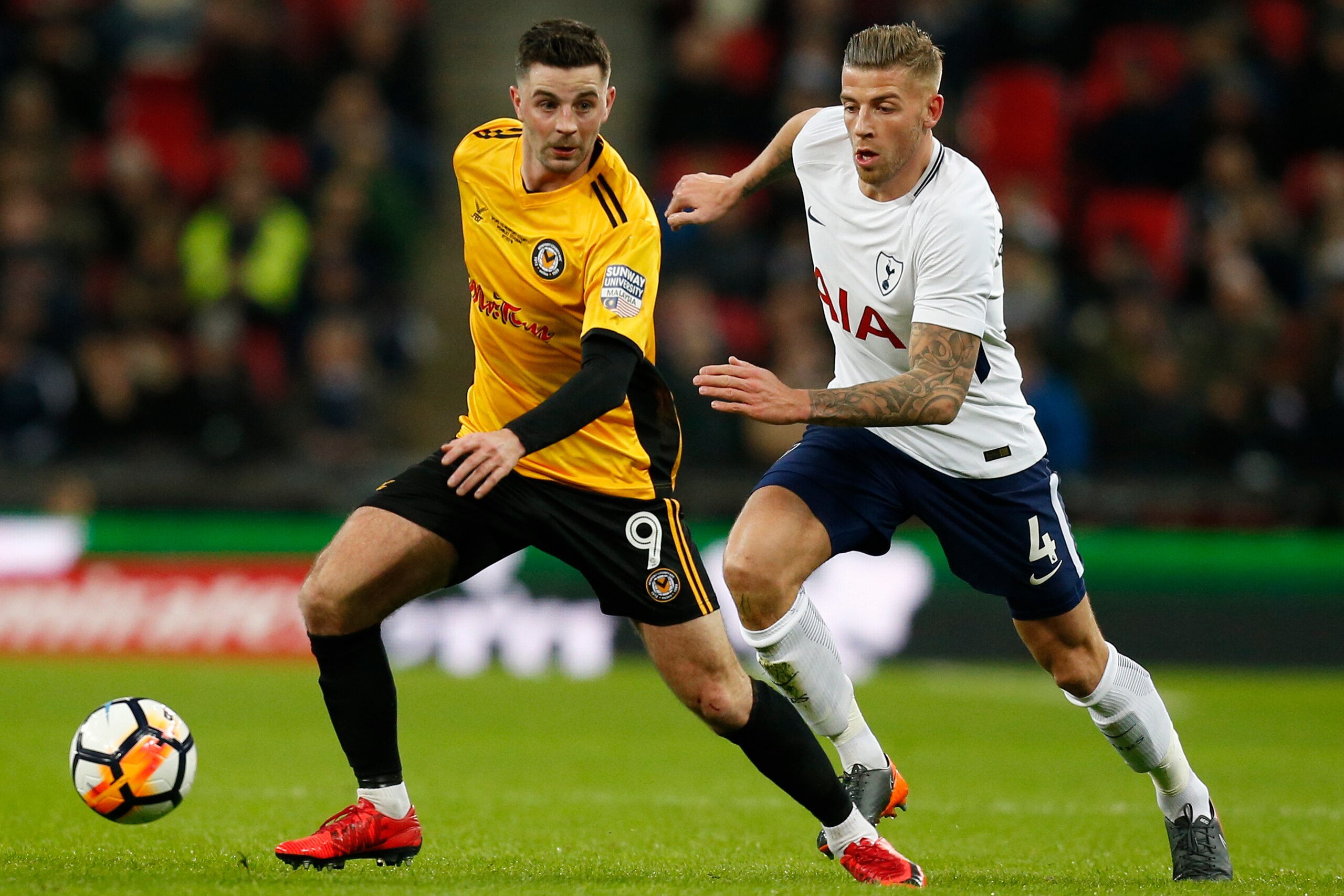 Newport County's Irish striker Padraig Amond (L) vies with Tottenham Hotspur's Belgian defender Toby Alderweireld during the English FA Cup fourth round replay football match between Tottenham Hotspur and Newport County at Wembley Stadium in London, on Fe