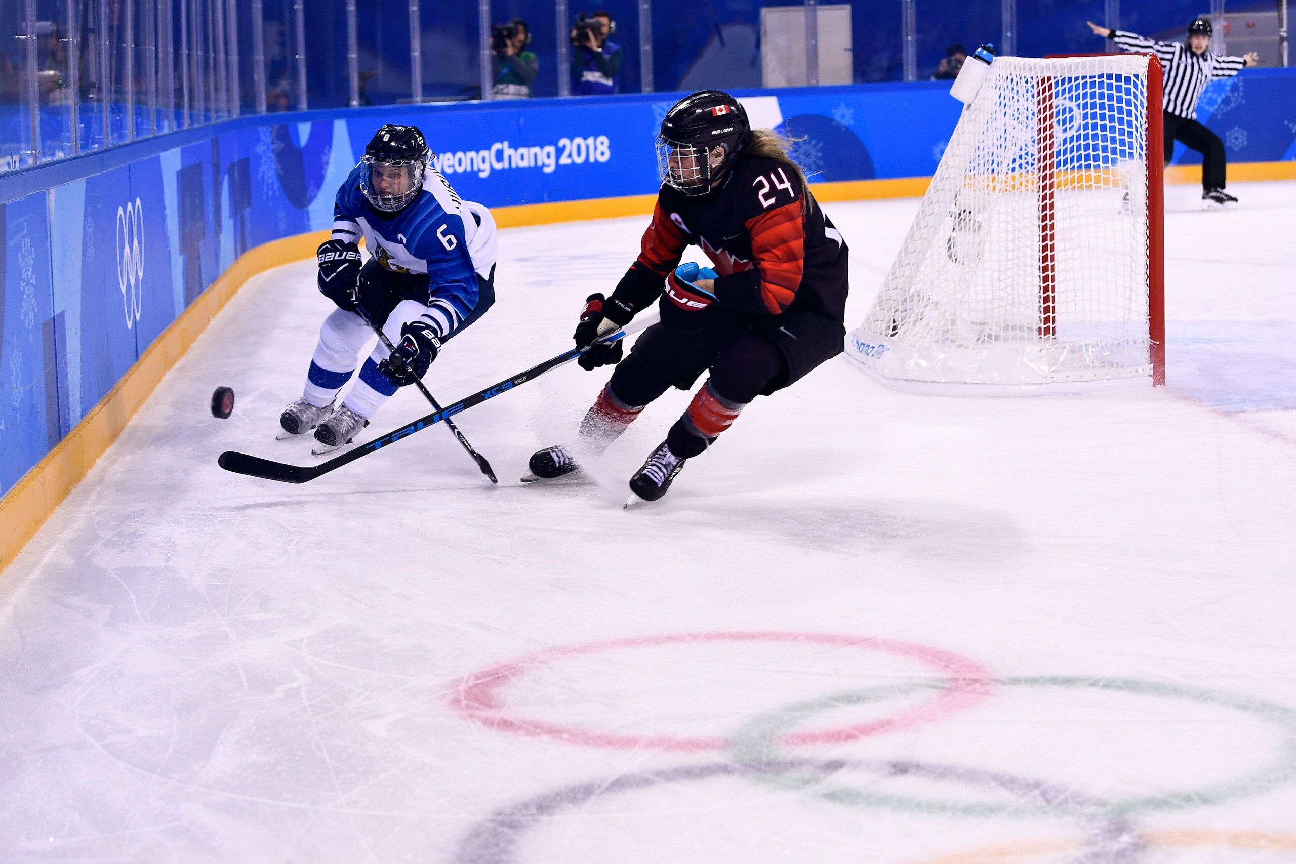 Finland's Jenni Hiirikoski (L) and Canada's Natalie Spooner fight for the puck during the final period of the women's preliminary round ice hockey match between Canada and Finland during the Pyeongchang 2018 Winter Olympic Games at the Kwandong Hockey Cen