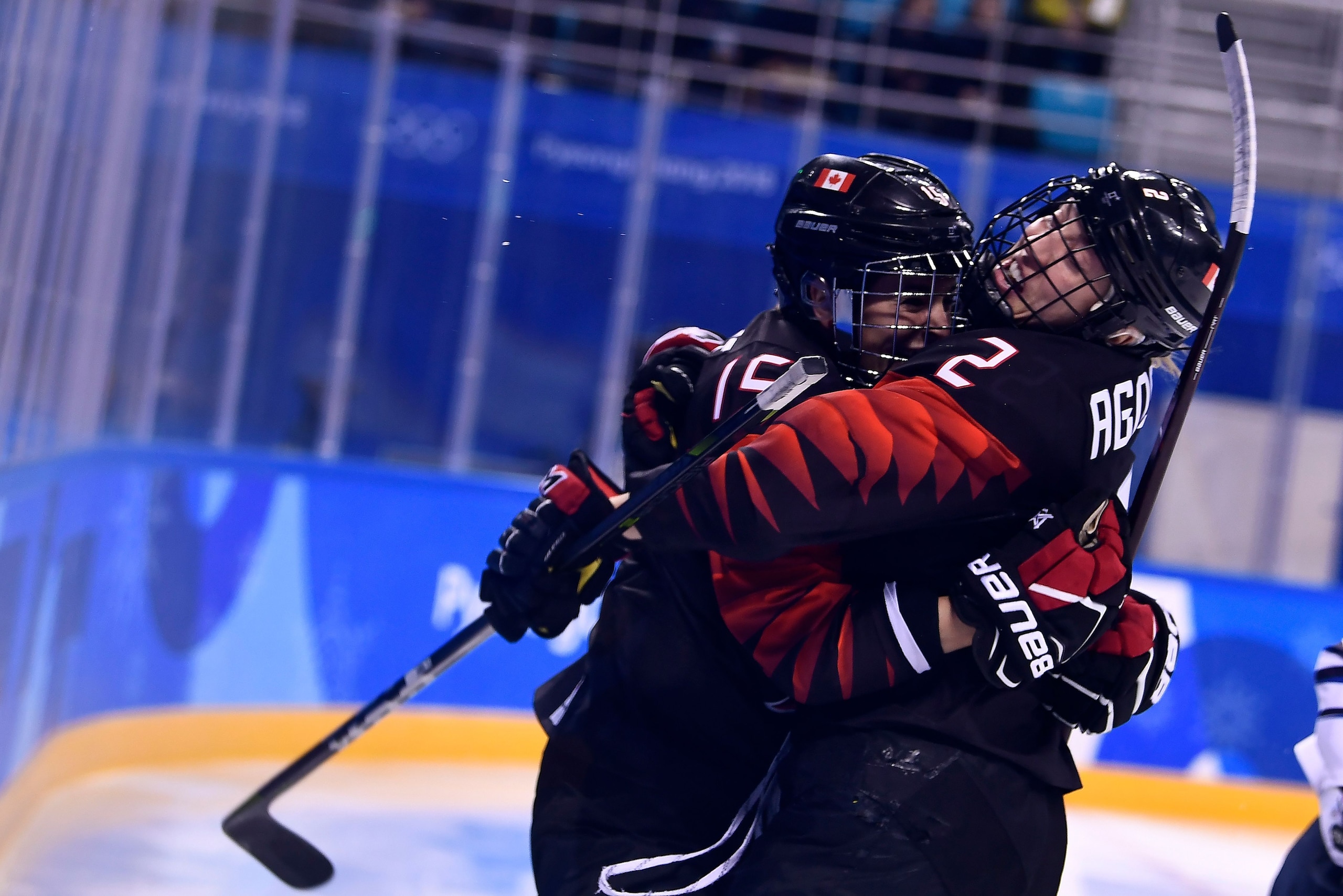 Canada's Melodie Daoust (L) and Canada's Meghan Agosta celebrate after a score during the first period of the women's preliminary round ice hockey match between Canada and Finland during the Pyeongchang 2018 Winter Olympic Games at the Kwandong Hockey Cen