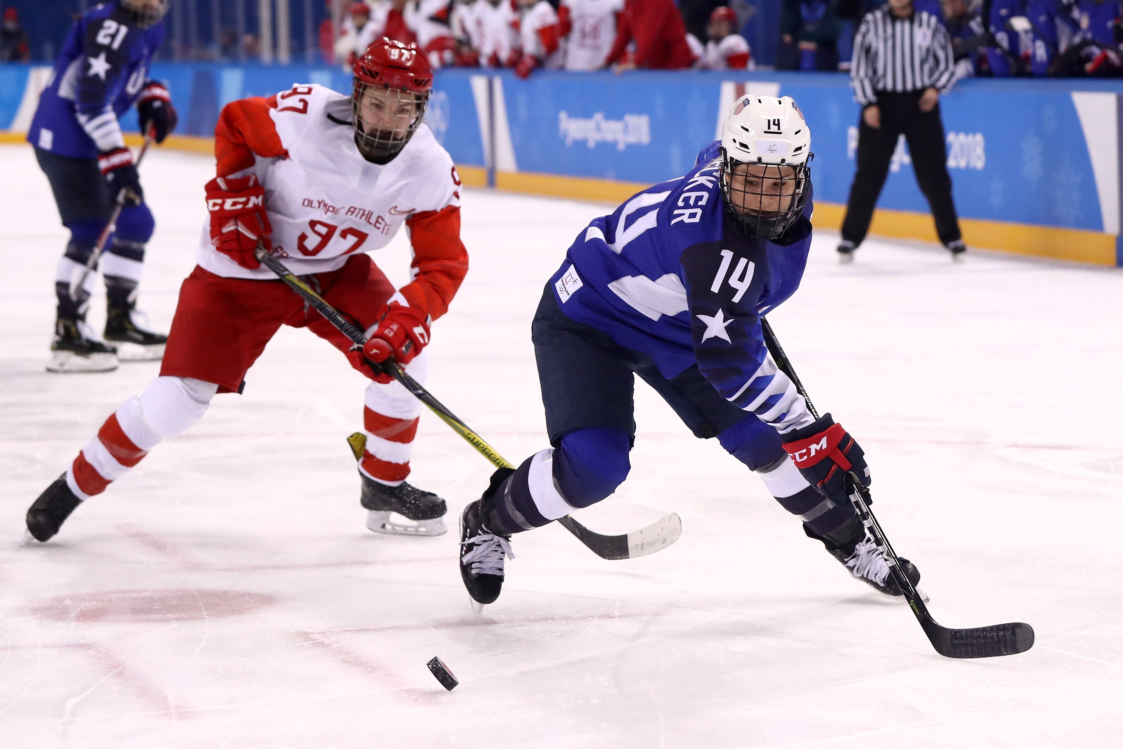 GANGNEUNG, SOUTH KOREA - FEBRUARY 13: Brianna Decker #14 of the United States controls the puck against Anna Shokhina #97 of Olympic Athlete from Russia in the first period during the Women's Ice Hockey Preliminary Round - Group A game on day four of the 