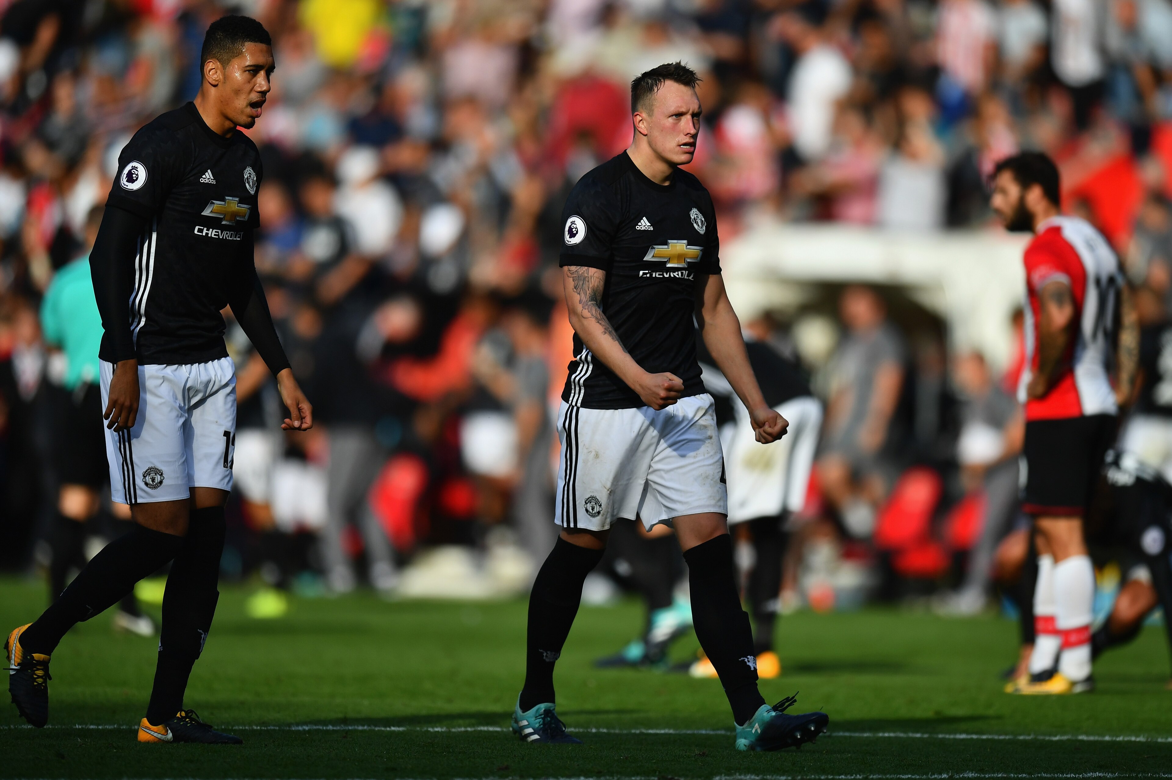 SOUTHAMPTON, ENGLAND - SEPTEMBER 23:  Phil Jones (C) and Chris Smalling (L) of Manchester United celeberate their victory in the Premier League match between Southampton and Manchester United at St Mary's Stadium on September 23, 2017 in Southampton, Engl