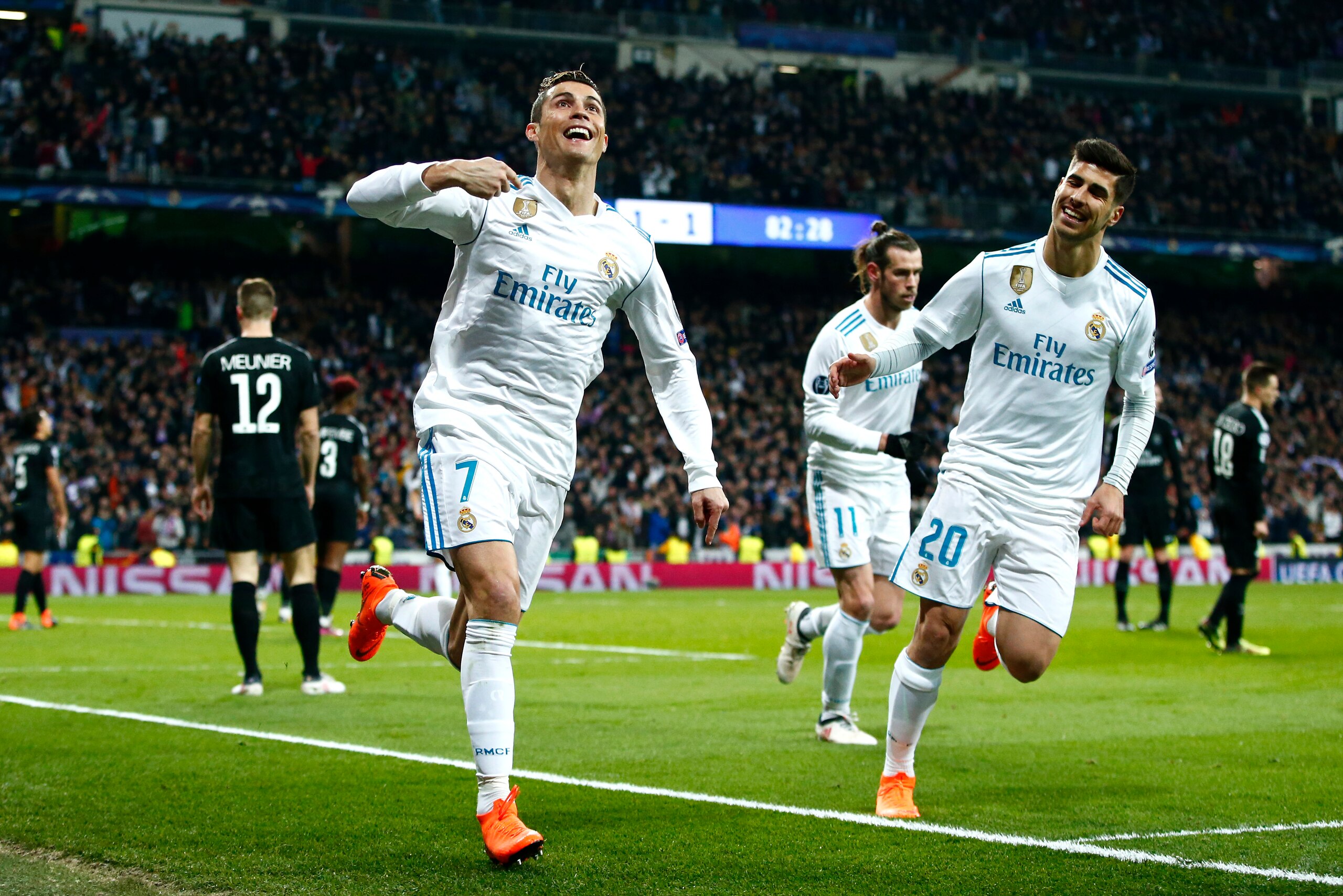 MADRID, SPAIN - FEBRUARY 14:  Cristiano Ronaldo of Real Madrid celebrates scoring the 2nd Real Madrid goal with Marco Asensio of Real Madrid during the UEFA Champions League Round of 16 First Leg match between Real Madrid and Paris Saint-Germain at Bernab