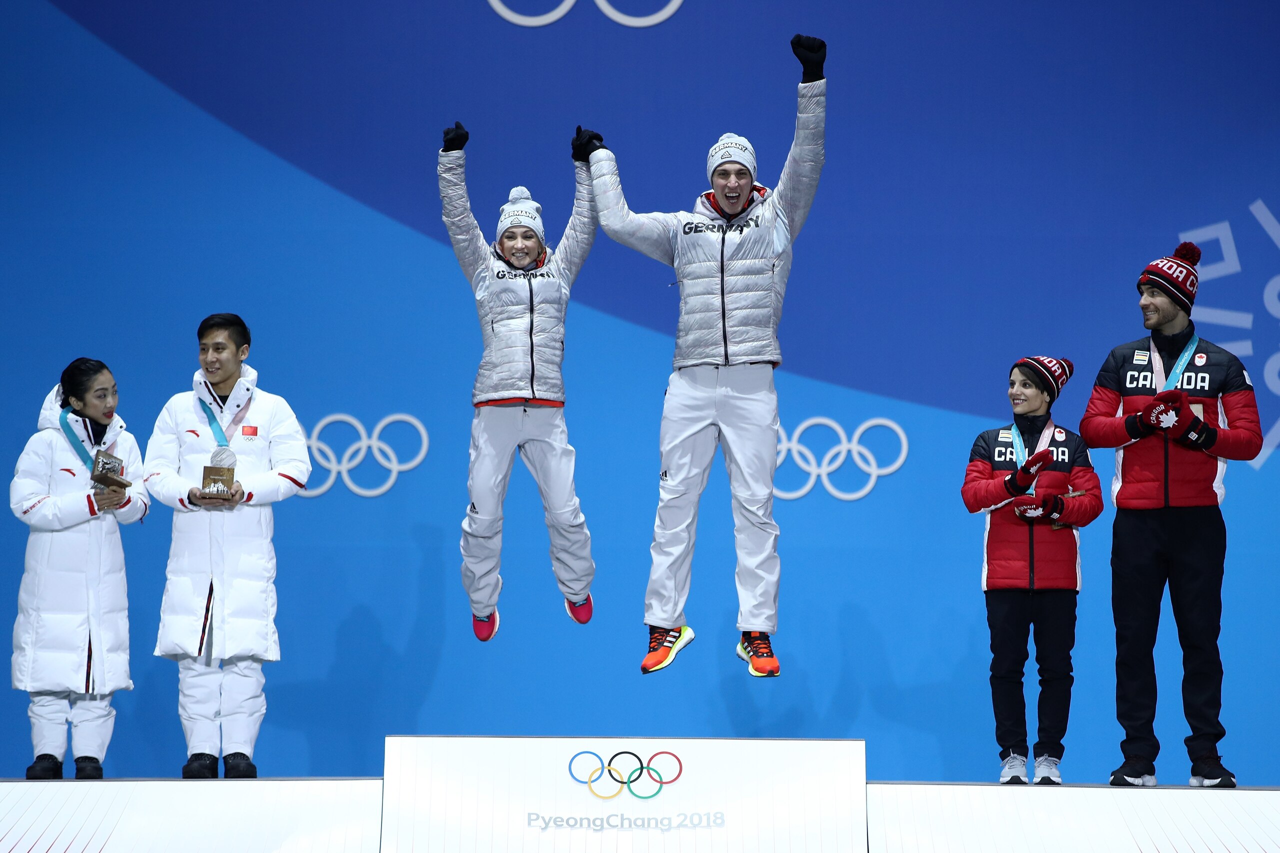 PYEONGCHANG-GUN, SOUTH KOREA - FEBRUARY 15:  (L-R) Silver medalists Wenjing Sui and Cong Han of China, gold medalists Aljona Savchenko and Bruno Massot of Germany and bronze medalists Meagan Duhamel and Eric Radford of Canada celebrate during the medal ce