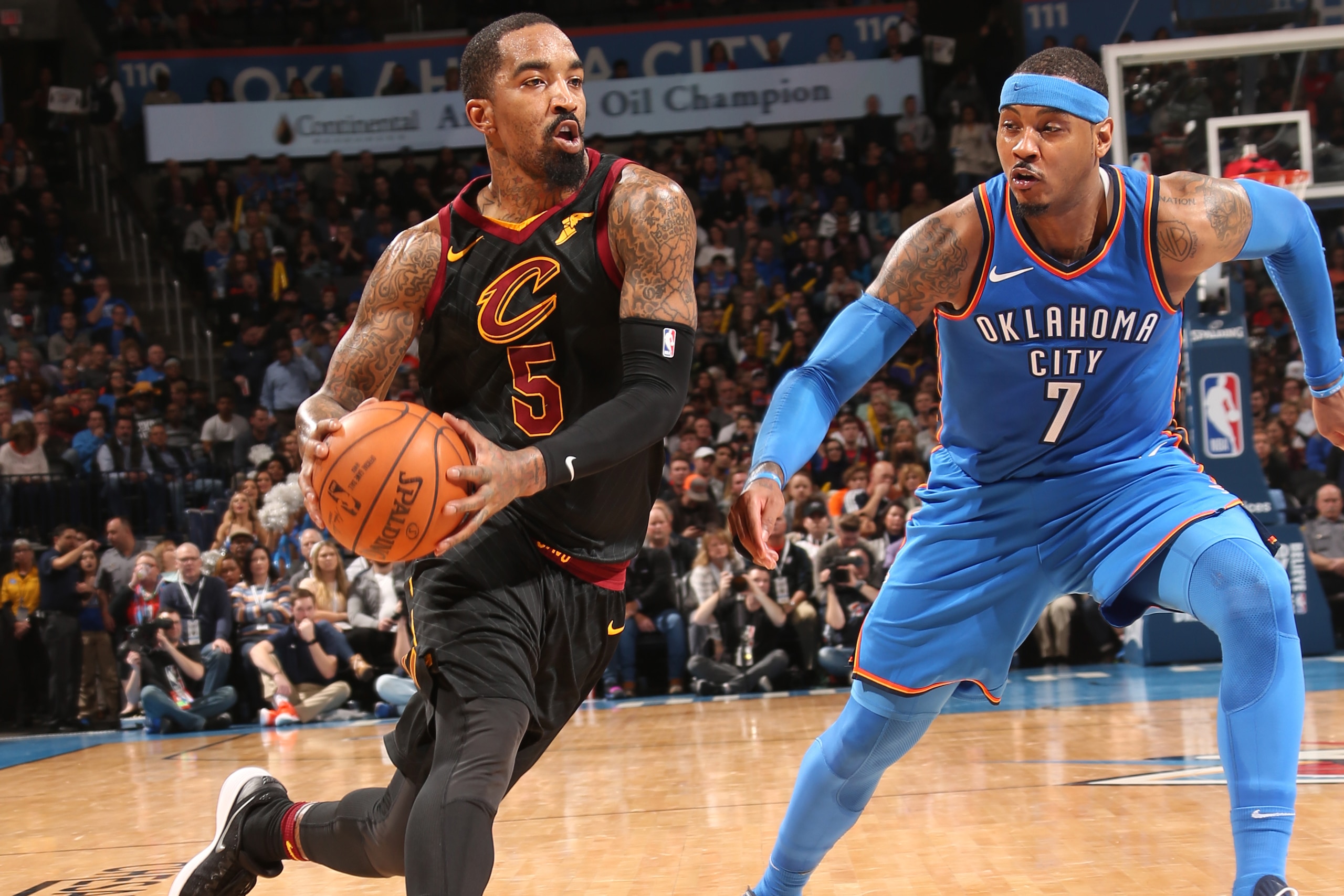 OKLAHOMA CITY, OK - FEBRUARY 13:  JR Smith #5 of the Cleveland Cavaliers handles the ball against Carmelo Anthony #7 of the Oklahoma City Thunder on February 13, 2018 at Chesapeake Energy Arena in Oklahoma City, Oklahoma. NOTE TO USER: User expressly ackn