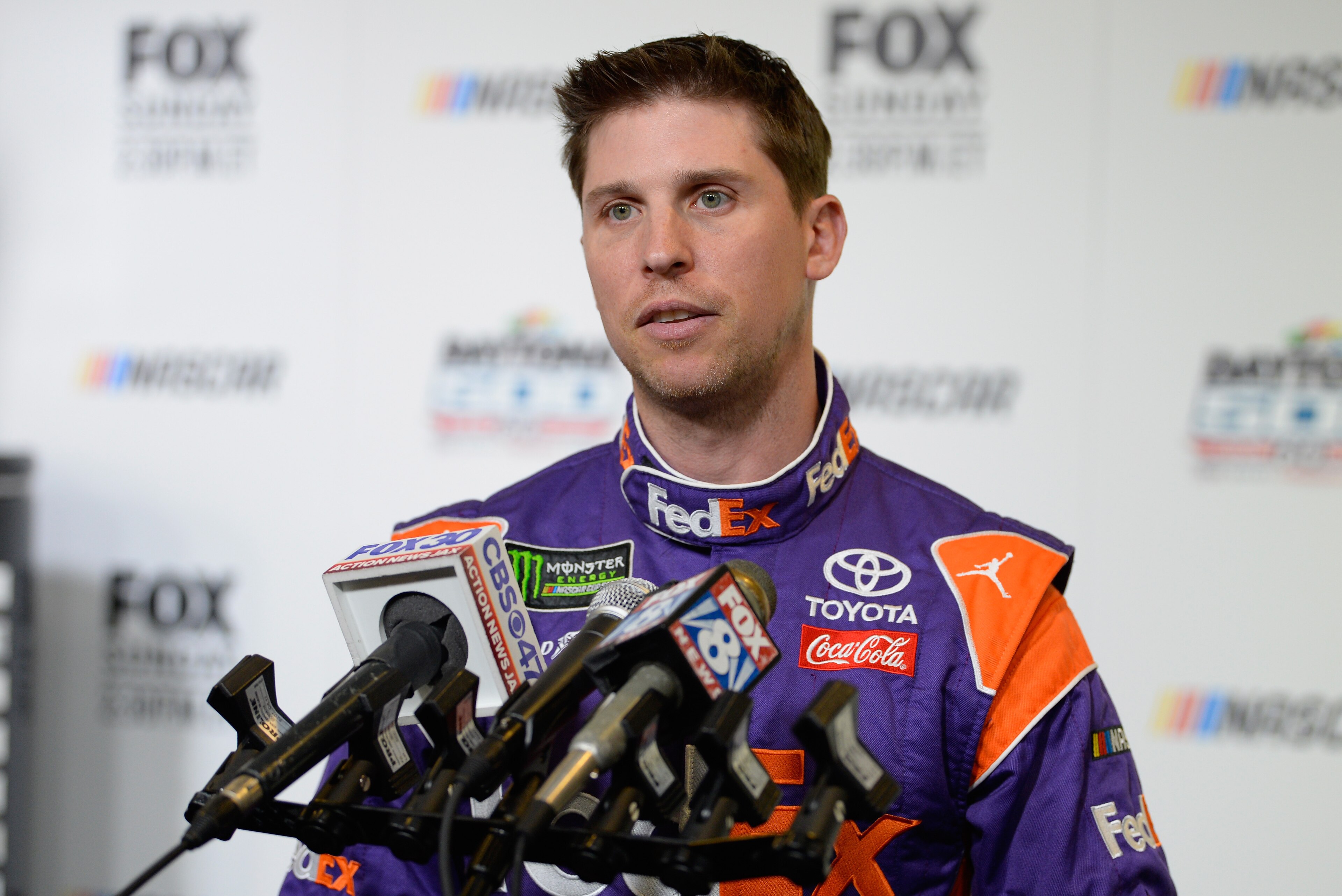 DAYTONA BEACH, FL - FEBRUARY 14:  Denny Hamlin, driver of the #11 FedEx Express Toyota, talks to the media during the Daytona 500 Media Day at Daytona International Speedway on February 14, 2018 in Daytona Beach, Florida.  (Photo by Robert Laberge/Getty I