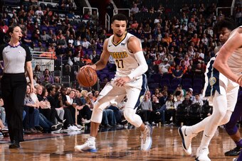 PHOENIX, AZ - FEBRUARY 10: Jamal Murray #27 of the Denver Nuggets handles the ball against the Phoenix Suns on February 10, 2018 at Talking Stick Resort Arena in Phoenix, Arizona. NOTE TO USER: User expressly acknowledges and agrees that, by downloading a