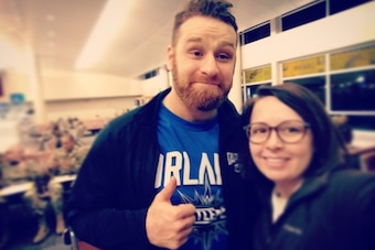 Sami Zayn poses with a fan at the San Antonio airport.