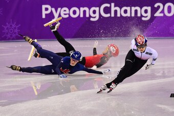 South Korea's Choi Minjeong (R) competes as Britain's Elise Christie (L) and China's Li Jinyu fall in the women's 1,500m short track speed skating semi-final event during the Pyeongchang 2018 Winter Olympic Games, at the Gangneung Ice Arena in Gangneung o
