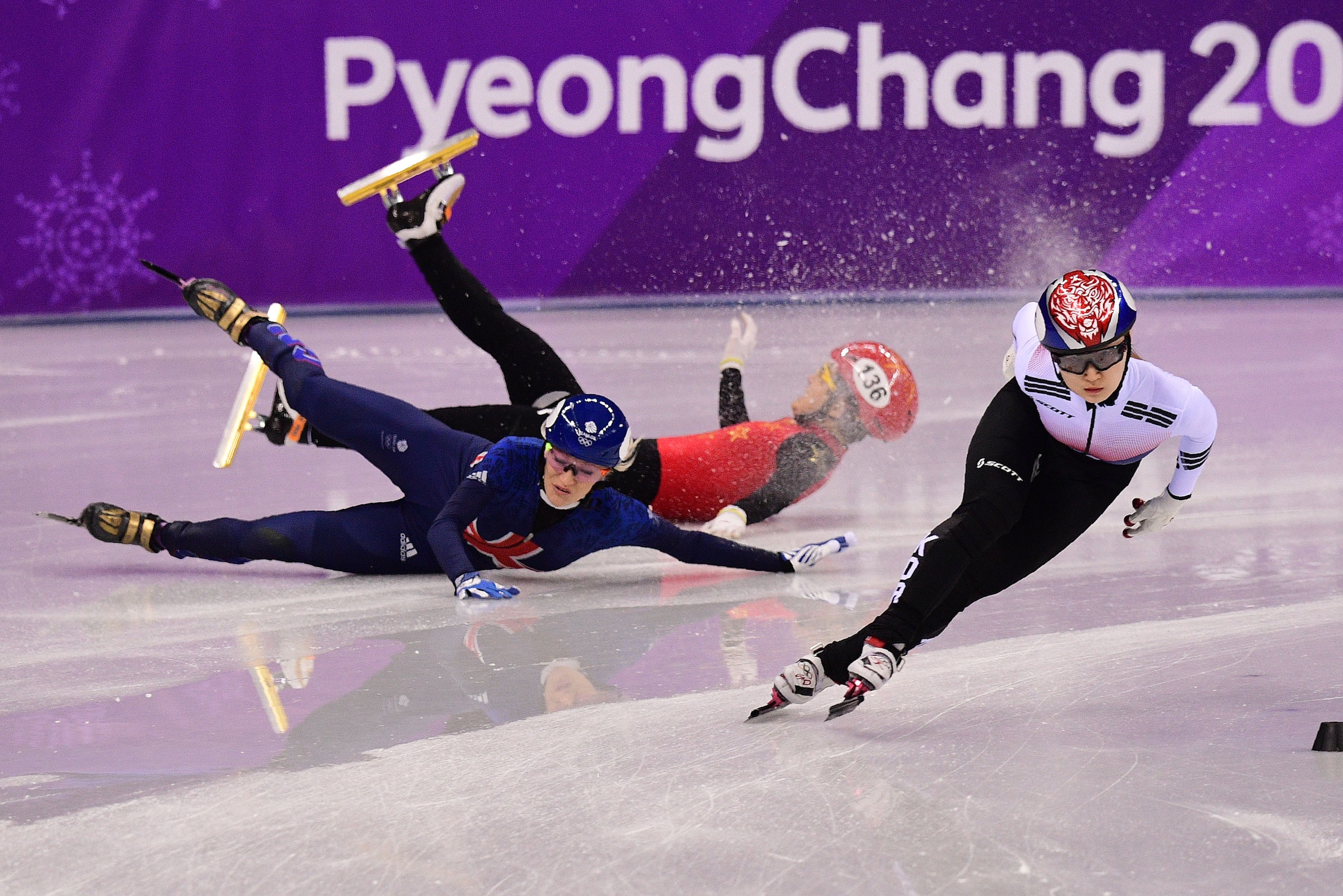 South Korea's Choi Minjeong (R) competes as Britain's Elise Christie (L) and China's Li Jinyu fall in the women's 1,500m short track speed skating semi-final event during the Pyeongchang 2018 Winter Olympic Games, at the Gangneung Ice Arena in Gangneung o