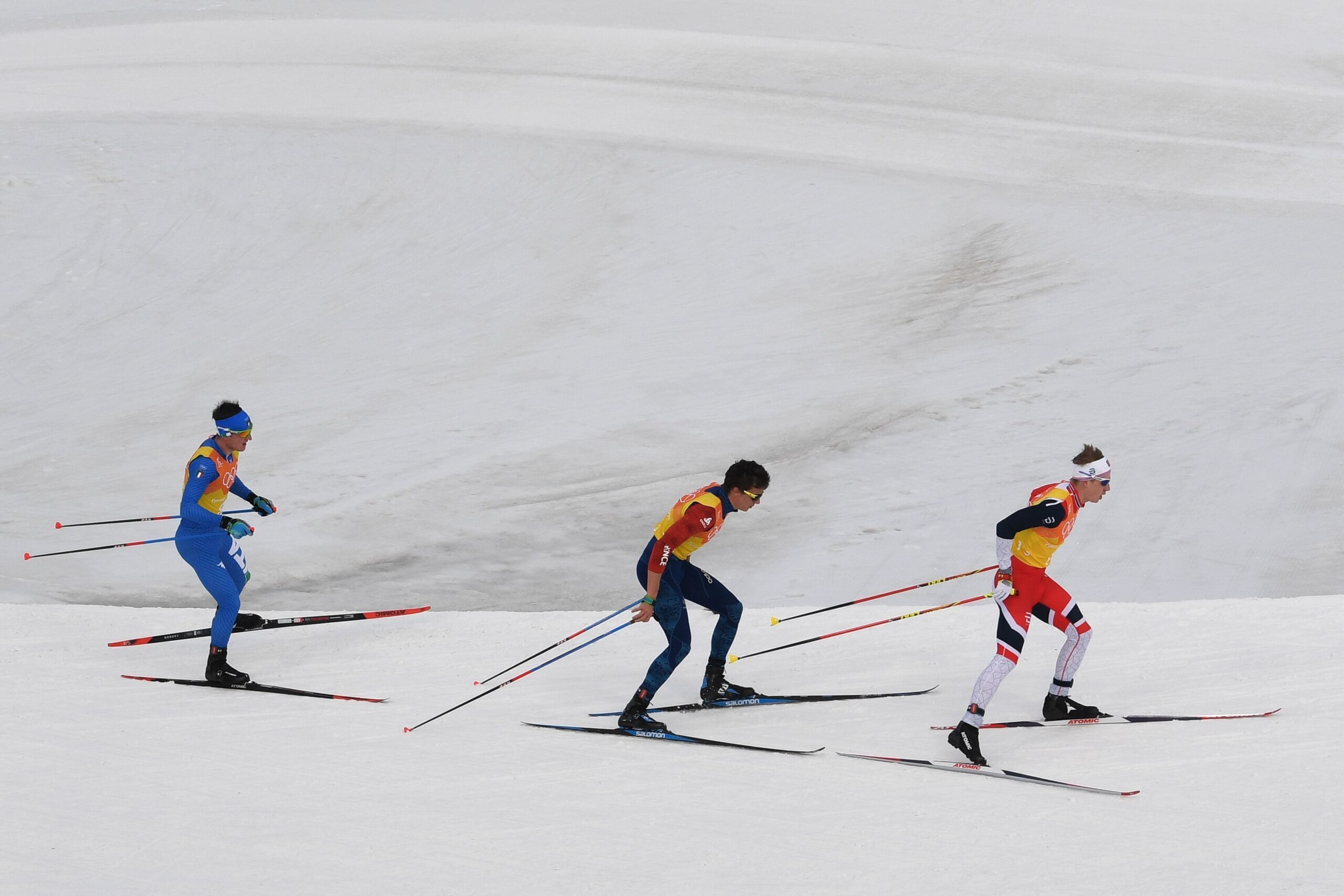 Italy's Giandomenico Salvadori, France's Clement Parisse and Sweden's Marcus Hellner compete during the men's 4x10kms classic freestyle cross country relay at the Alpensia cross country ski centre during the Pyeongchang 2018 Winter Olympic Games on Februa