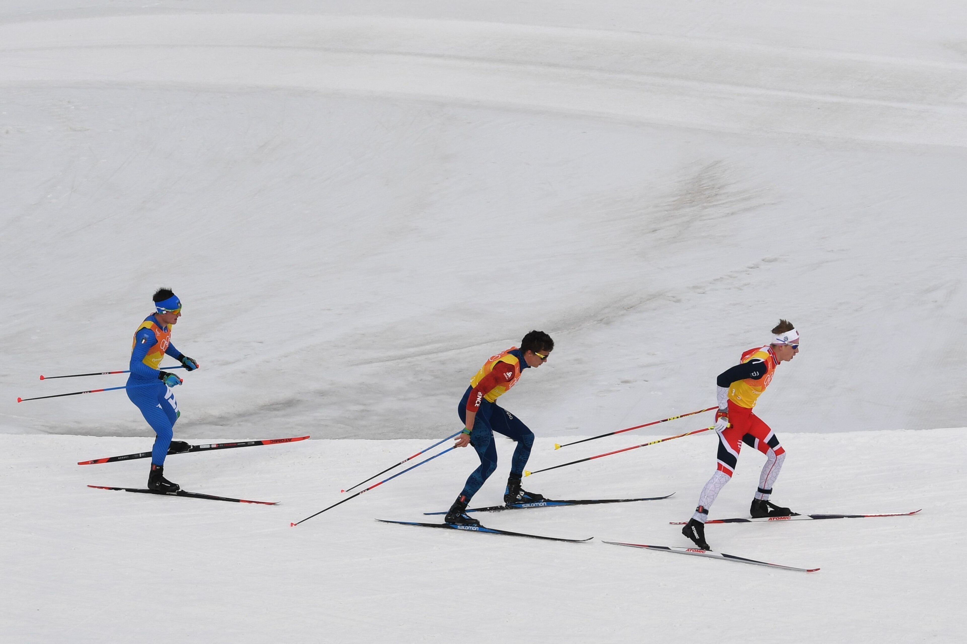Italy's Giandomenico Salvadori, France's Clement Parisse and Sweden's Marcus Hellner compete during the men's 4x10kms classic freestyle cross country relay at the Alpensia cross country ski centre during the Pyeongchang 2018 Winter Olympic Games on Februa