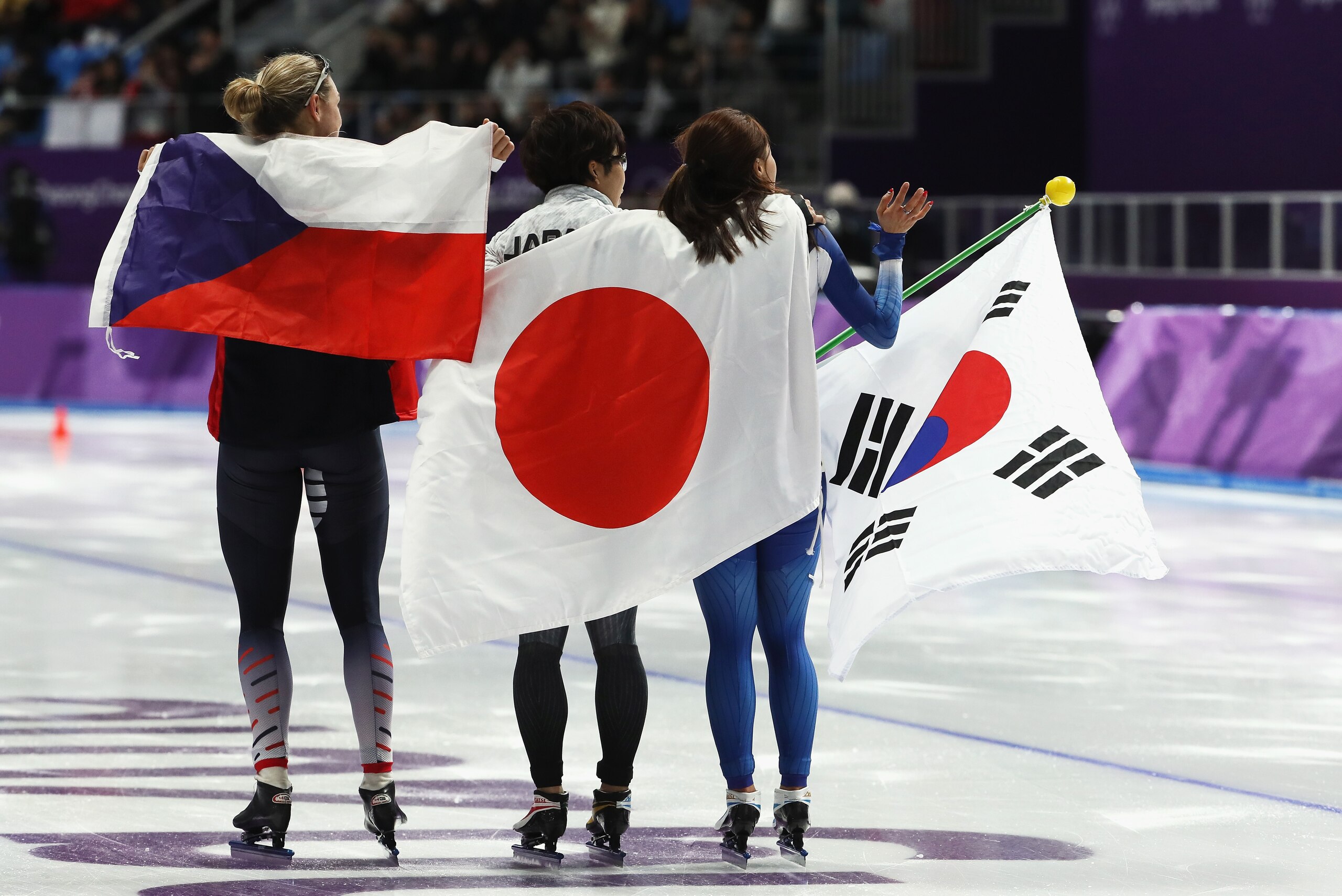 GANGNEUNG, SOUTH KOREA - FEBRUARY 18:  Bronze medalist Karolina Erbanova of the Czech Republic, gold medalist Nao Kodaira of Japan and silver medalist Sang-Hwa Lee of Korea celebrate after the Ladies' 500m Individual Speed Skating Final on day nine of the