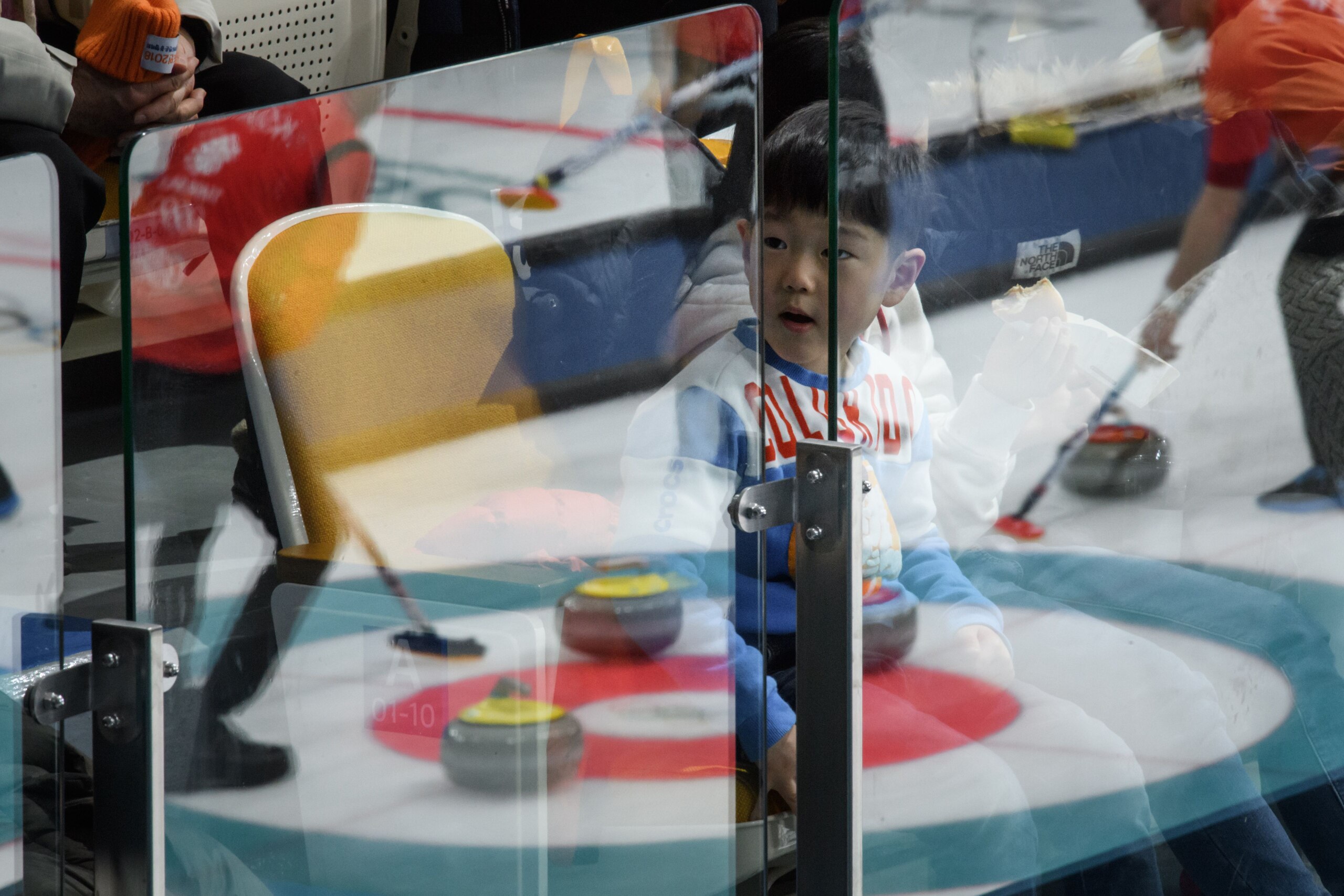 A child watches curling at the curling venue of the Pyeongchang Winter Olympic games, in Gangneung on February 19, 2018.    / AFP PHOTO / Ed JONES        (Photo credit should read ED JONES/AFP/Getty Images)