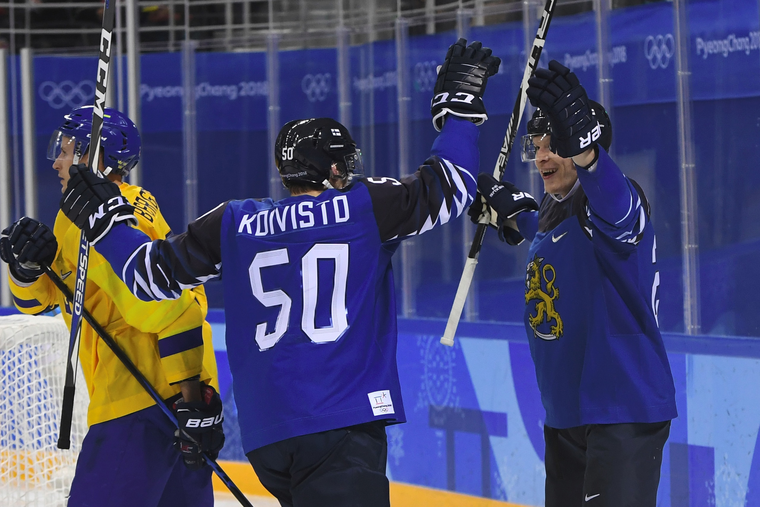 Finland's Joonas Kemppainen (R) celebrates scoring with teammate Miika Koivisto in the men's preliminary round ice hockey match between Sweden and Finland during the Pyeongchang 2018 Winter Olympic Games at the Kwandong Hockey Centre in Gangneung on Febru