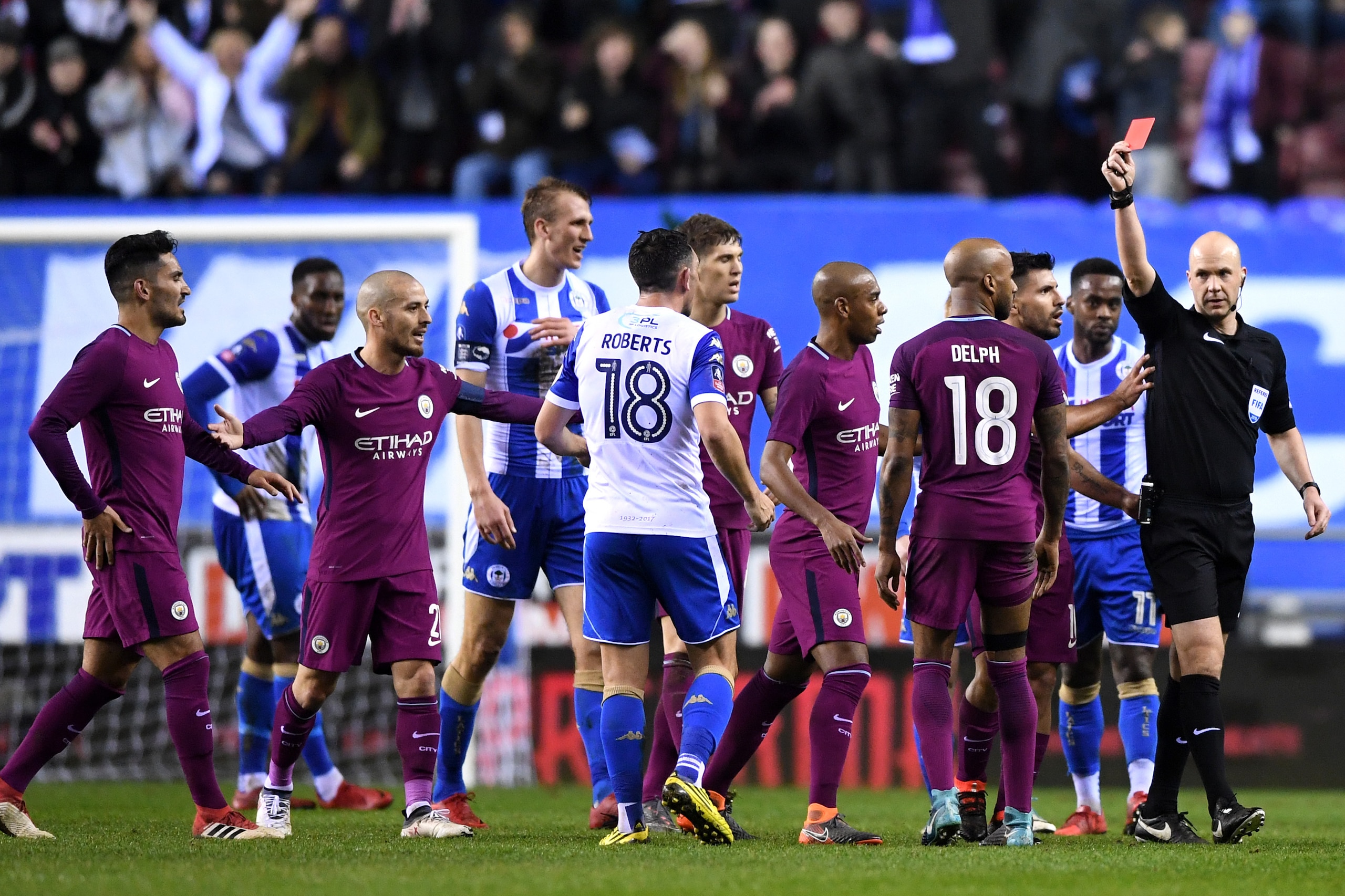 WIGAN, ENGLAND - FEBRUARY 19:  Fabian Delph of Manchester City is shown a red card by referee Anthony Taylor during the Emirates FA Cup Fifth Round match between Wigan Athletic and Manchester City at DW Stadium on February 19, 2018 in Wigan, England.  (Ph