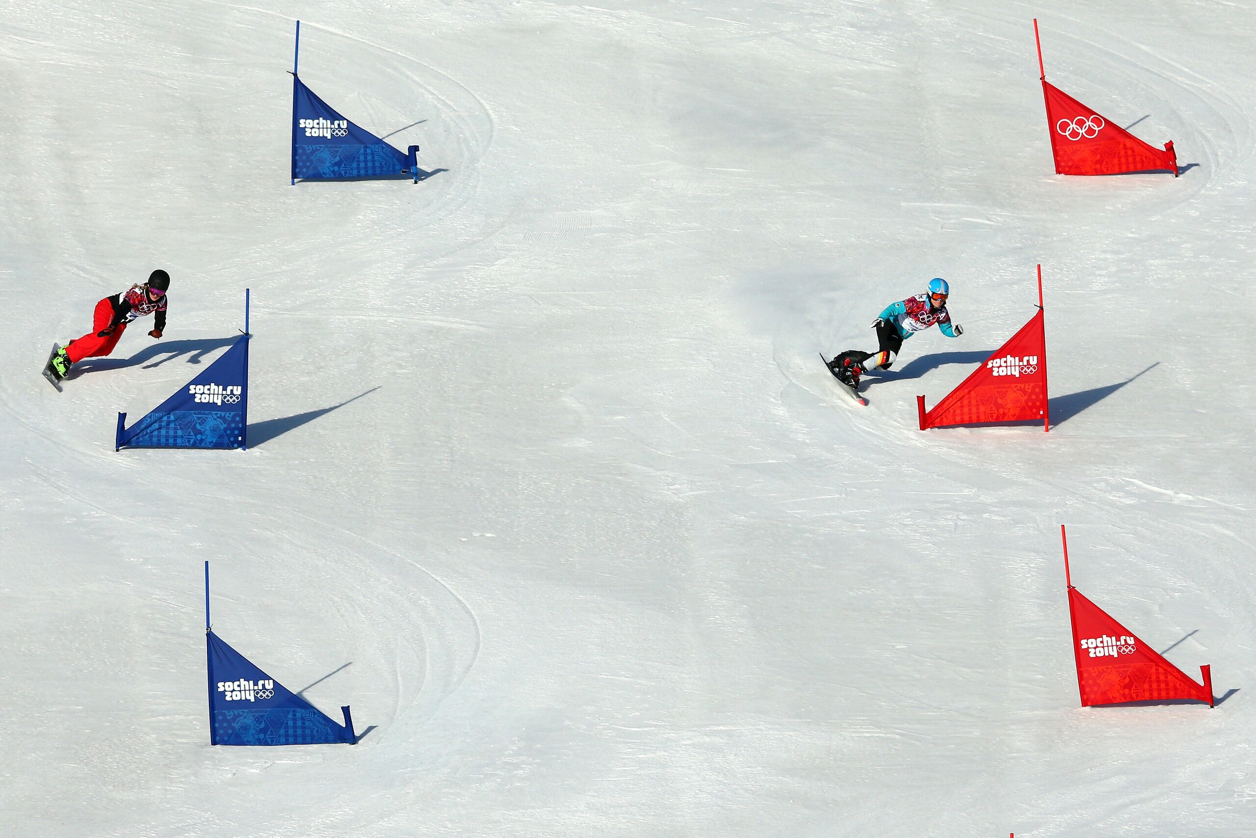 SOCHI, RUSSIA - FEBRUARY 22: Patrizia Kummer of Switzerland (L) and Selina Joerg of Germany compete in the Snowboard Ladies' Parallel Slalom Qualification on day 15 of the 2014 Winter Olympics at Rosa Khutor Extreme Park on February 22, 2014 in Sochi, Rus
