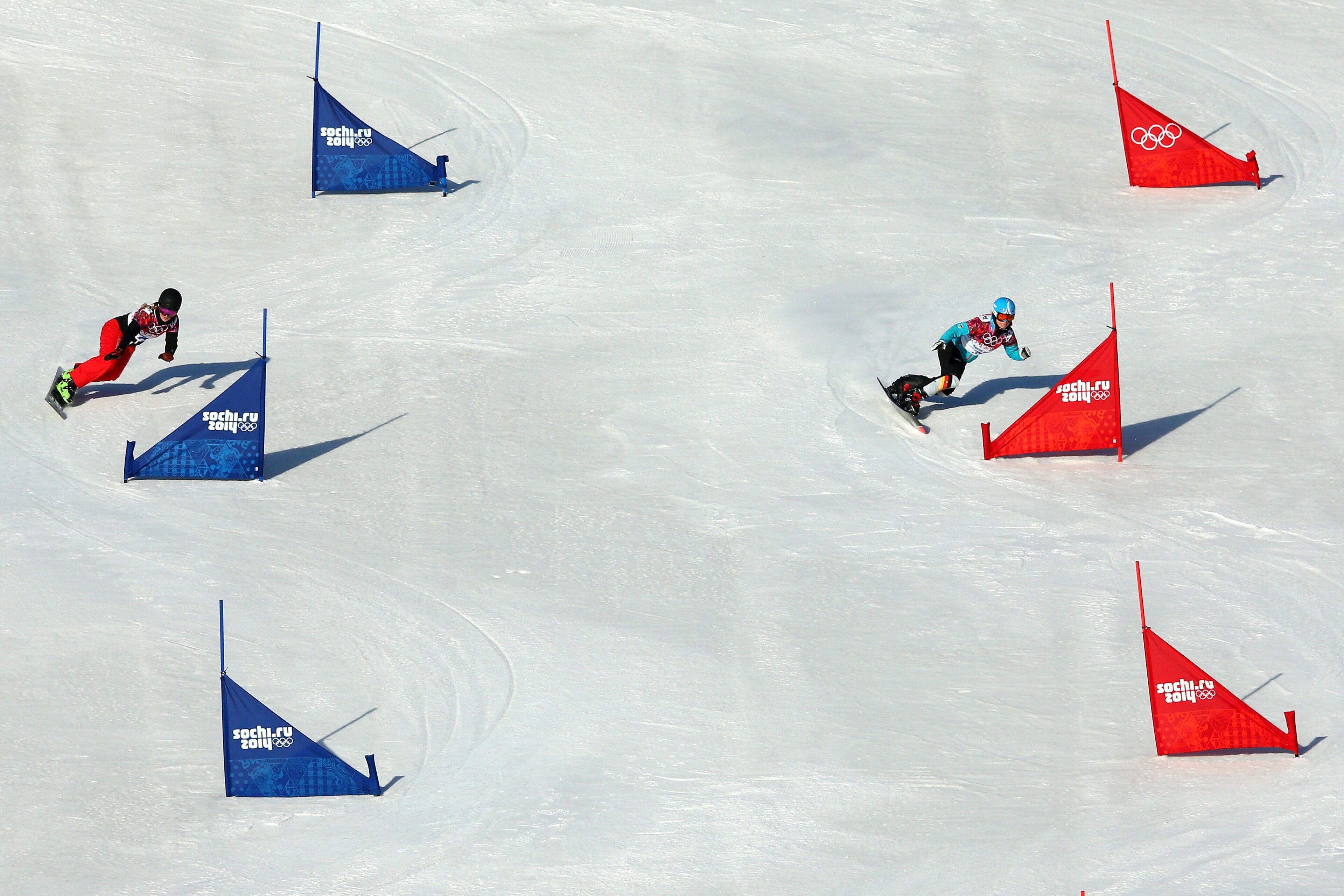 SOCHI, RUSSIA - FEBRUARY 22: Patrizia Kummer of Switzerland (L) and Selina Joerg of Germany compete in the Snowboard Ladies' Parallel Slalom Qualification on day 15 of the 2014 Winter Olympics at Rosa Khutor Extreme Park on February 22, 2014 in Sochi, Rus