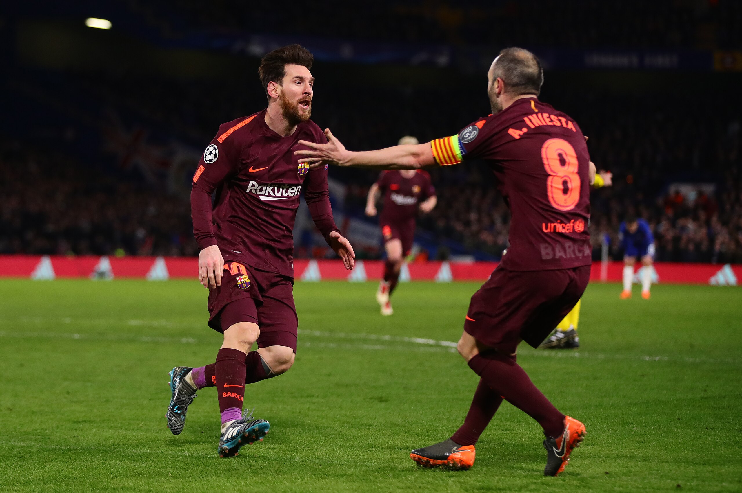 LONDON, ENGLAND - FEBRUARY 20:  Lionel Messi of FC Barcelona celebrates with teammate Andres Iniesta after scoring his sides first goal during the UEFA Champions League Round of 16 First Leg match between Chelsea FC and FC Barcelona at Stamford Bridge on 