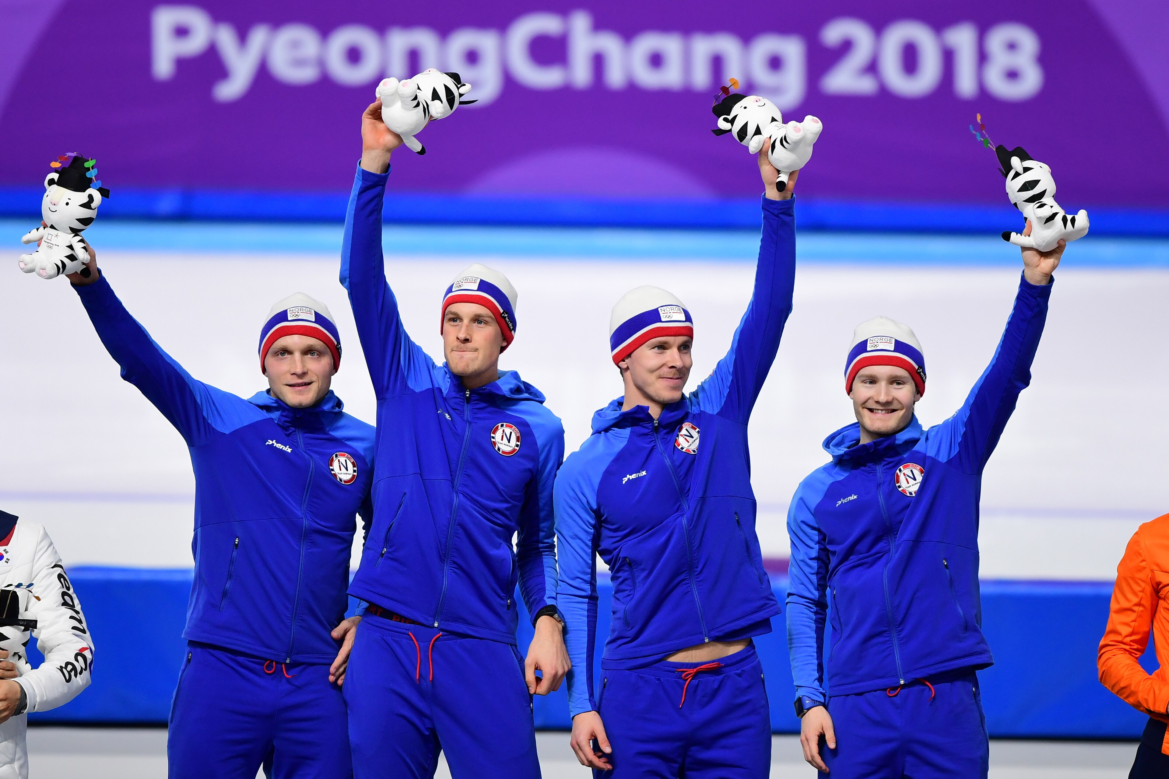 The Norway team celebrates their gold on the podium during the men's team pursuit speed skating event venue ceremony at the Pyeongchang 2018 Winter Olympic Games at the Gangneung Oval in Gangneung on February 21, 2018. / AFP PHOTO / Roberto SCHMIDT The Norway team celebrates their gold on the podium during the men's team pursuit speed skating event venue ceremony at the Pyeongchang 2018 Winter Olympic Games at the Gangneung Oval in Gangneung on February 21, 2018. / AFP PHOTO / Roberto SCHMIDT