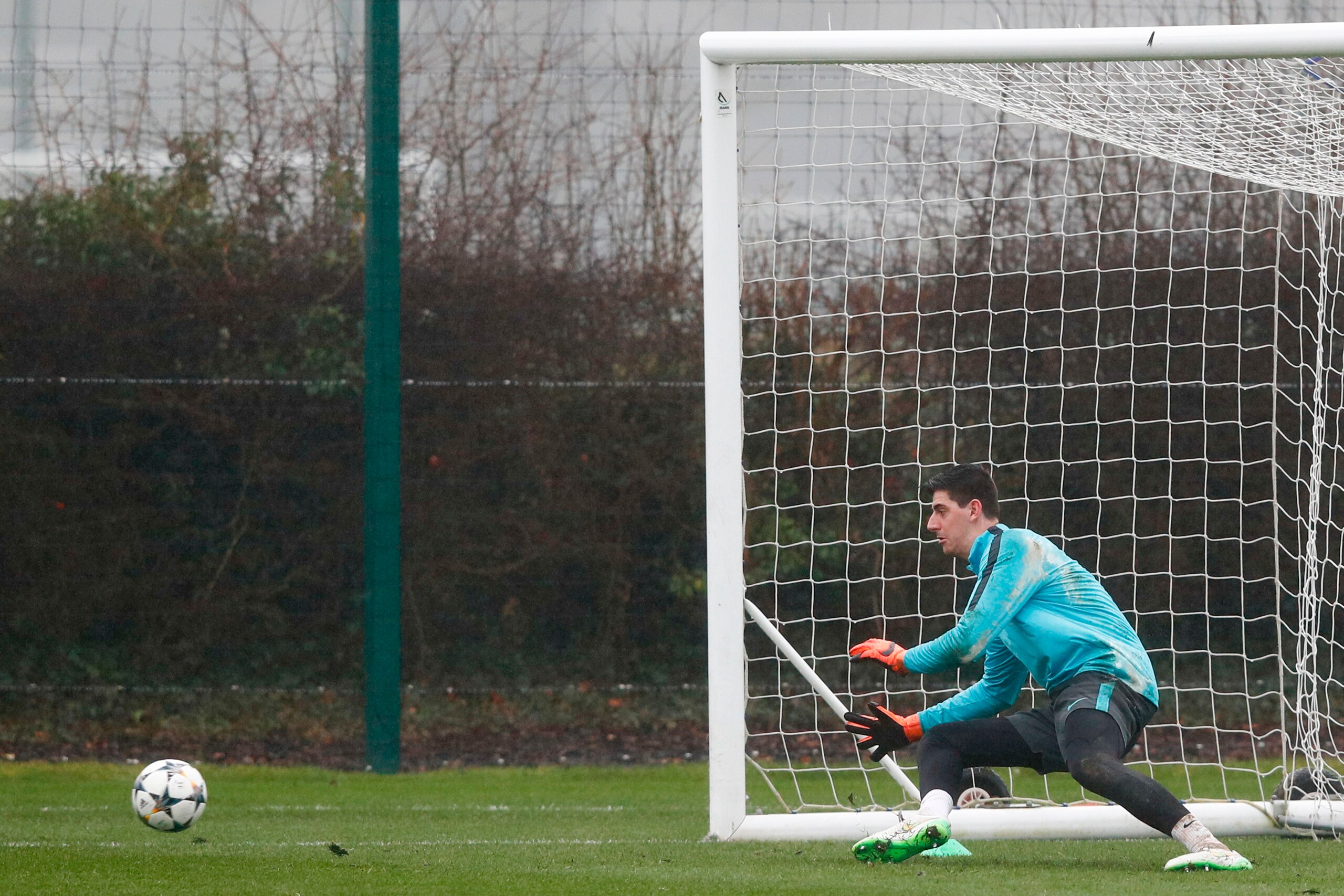 Chelsea's Belgian goalkeeper Thibaut Courtois practices his saves during a training session at Chelsea's Cobham training facility in Stoke D'Abernon, southwest of London on February 19, 2018, on the eve of their UEFA Champions League round of 16 football 