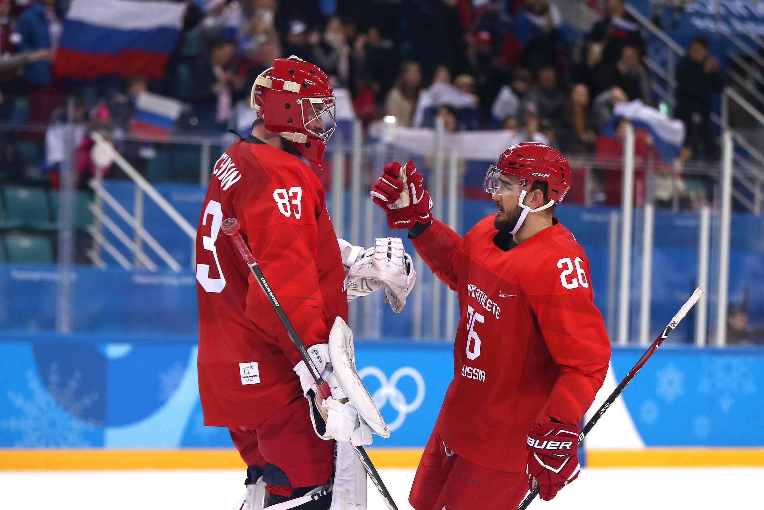 GANGNEUNG, SOUTH KOREA - FEBRUARY 21:  Vasili Koshechkin #83 of Olympic Athlete from Russia celebrates with his teammates Vyacheslav Voinov #26 after defeating Team Norway in the Men's Play-offs Quarterfinals on day twelve of the PyeongChang 2018 Winter O