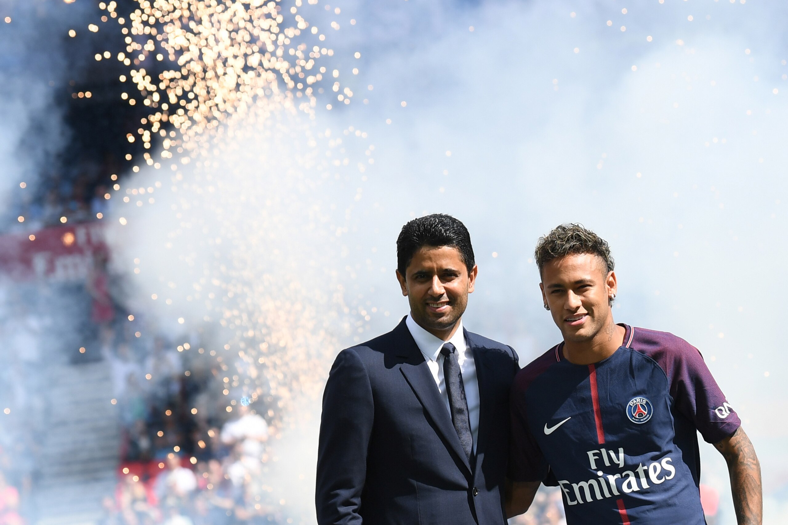 TOPSHOT - Paris Saint-Germain's Brazilian forward Neymar (R) poses with Paris Saint Germain's (PSG) Qatari president Nasser Al-Khelaifi (L) during his presentation to the fans at the Parc des Princes stadium in Paris, on August 5, 2017.
Brazil superstar N
