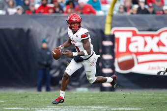 JACKSONVILLE, FL - DECEMBER 30: Lamar Jackson #8 of the Louisville Cardinals looks to pass against the Mississippi State Bulldogs during the TaxSlayer Bowl at EverBank Field on December 30, 2017 in Jacksonville, Florida. The Bulldogs won 31-27. (Photo by 