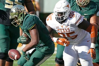 WACO, TX - DECEMBER 5: Johnny Jefferson #5 of the Baylor Bears fumbles against Poona Ford #95 of the Texas Longhorns in the fourth quarter at McLane Stadium on December 5, 2015 in Waco, Texas. (Photo by Ron Jenkins/Getty Images)