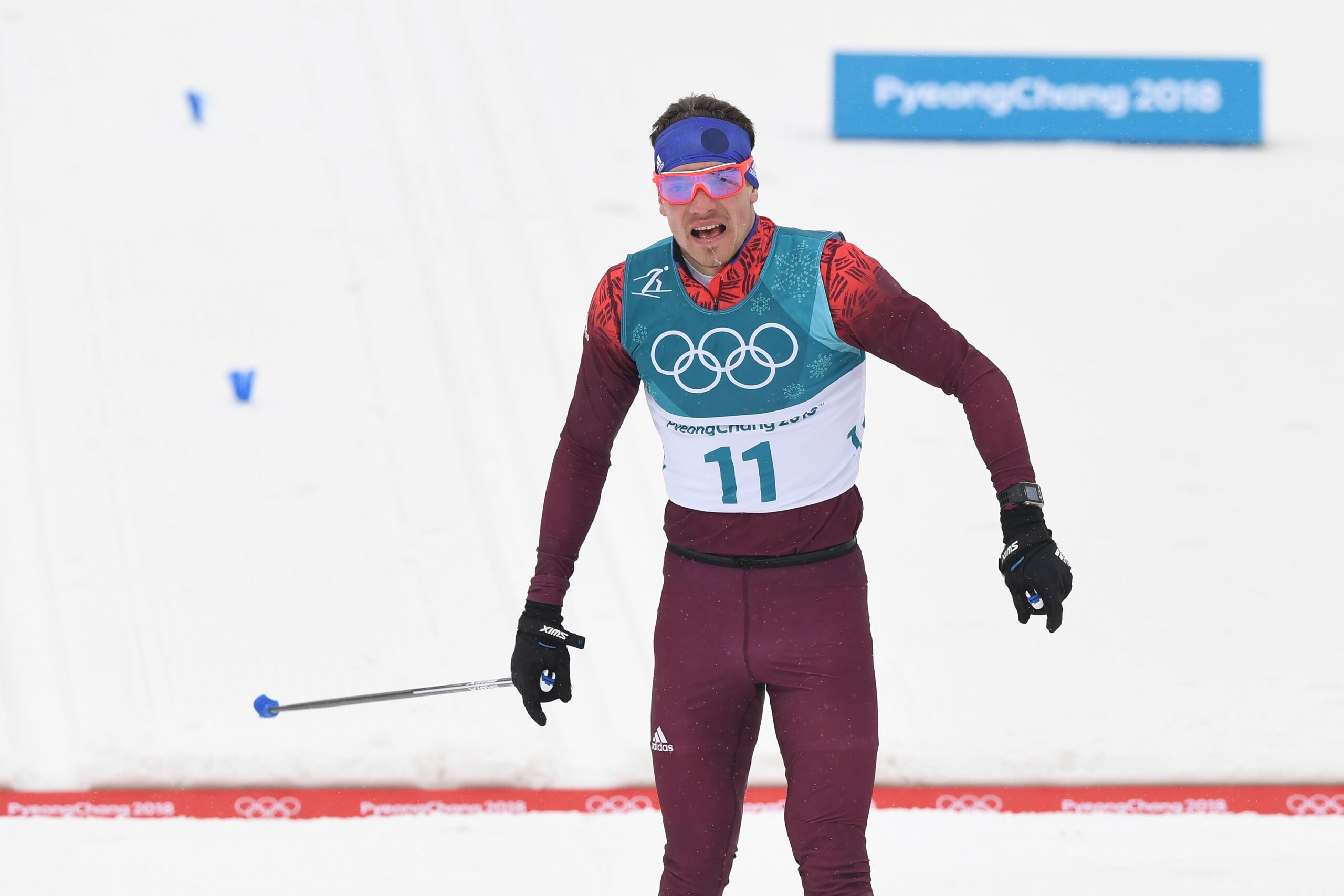 Russia's Alexander Bolshunov crosses the finish line to win silver in the men's 50km cross country mass start classic at the Alpensia cross country ski centre during the Pyeongchang 2018 Winter Olympic Games on February 24, 2018 in Pyeongchang.  / AFP PHO