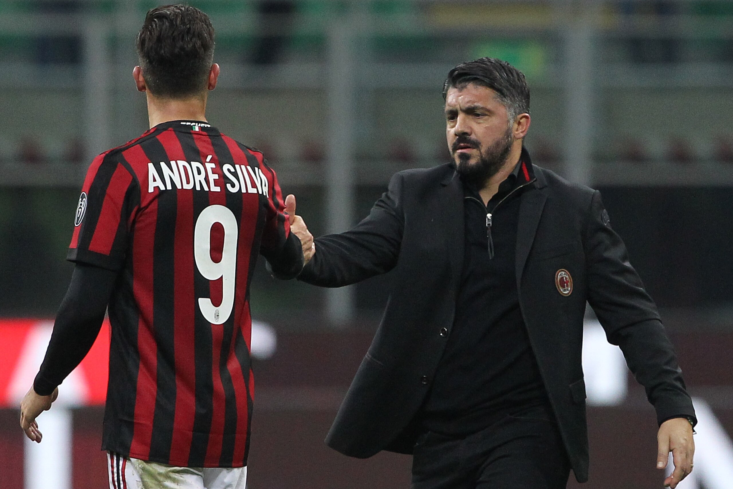 MILAN, ITALY - DECEMBER 13:  Andre Silva (L) of AC Milan shakes hands with AC Milan coach Gennaro Gattuso (R) at the end of the Tim Cup match between AC Milan and Hellas Verona FC at Stadio Giuseppe Meazza on December 13, 2017 in Milan, Italy.  (Photo by 