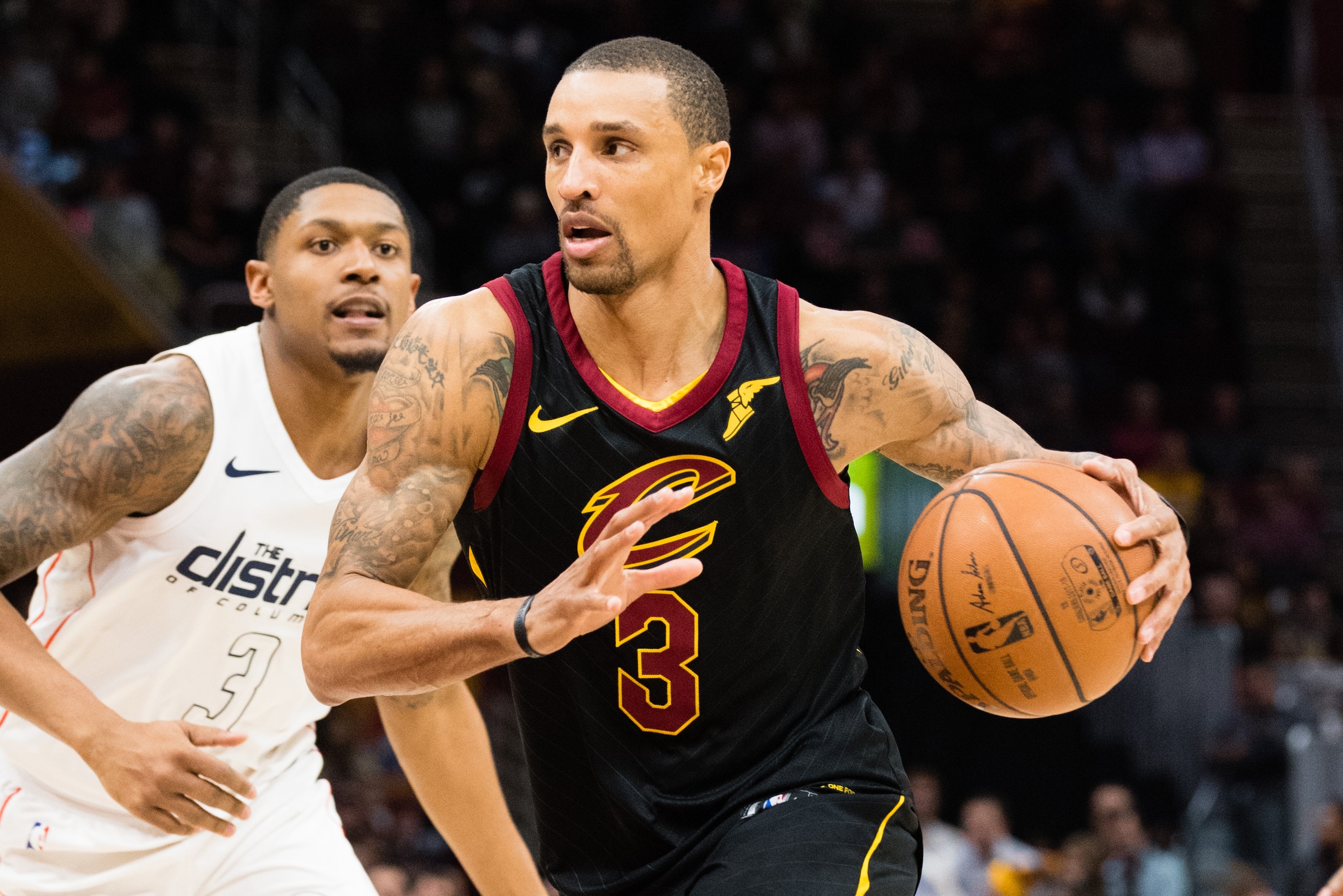 CLEVELAND, OH - FEBRUARY 22: George Hill #3 of the Cleveland Cavaliers drives around Bradley Beal #3 of the Washington Wizards during the second half at Quicken Loans Arena on February 22, 2018 in Cleveland, Ohio. The Wizards defeated the Cavaliers 110-10