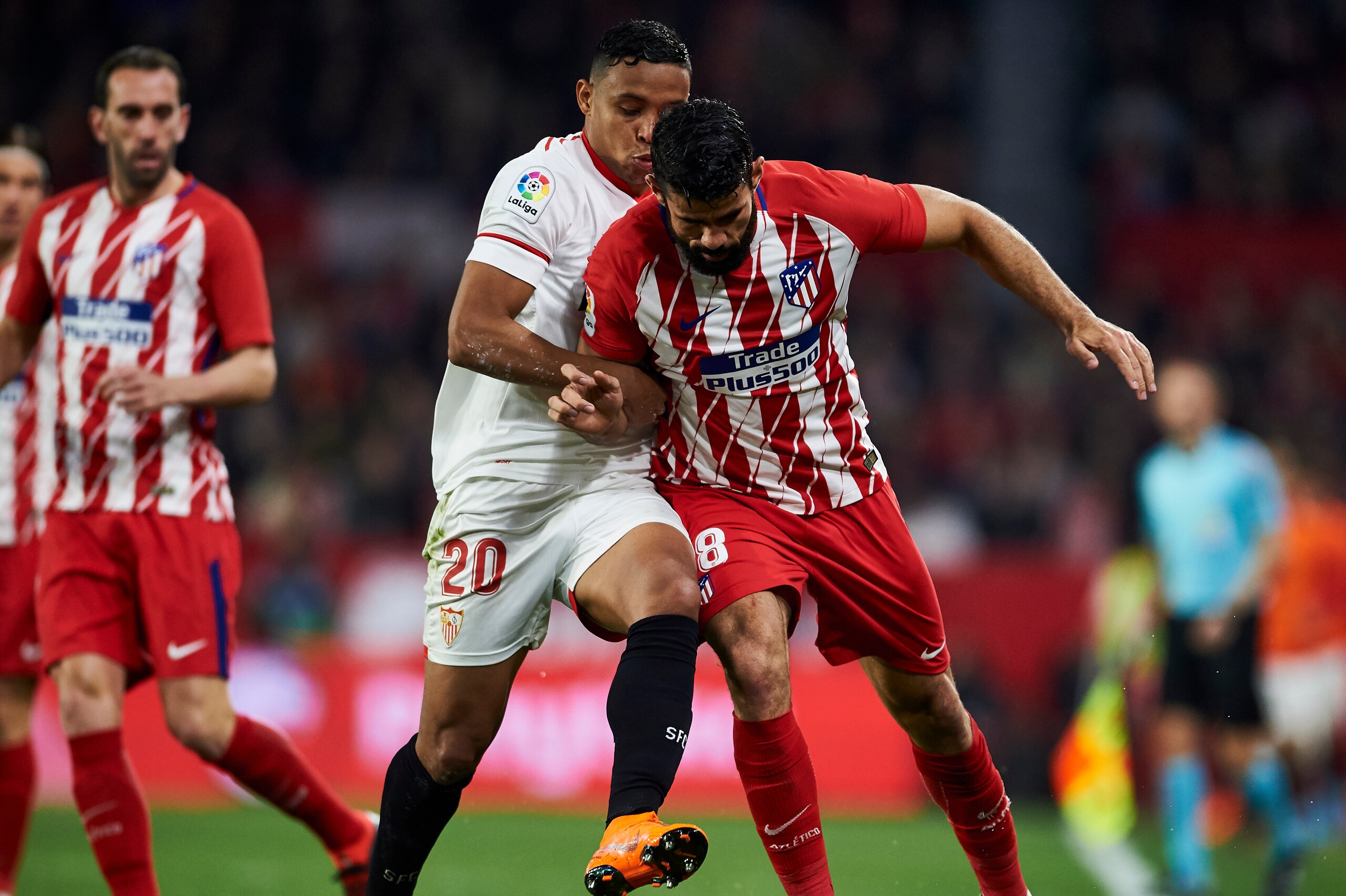 SEVILLE, SPAIN - FEBRUARY 25:  Diego Costa of Atletico Madrid competes for the ball with Luis Muriel of Sevilla CF during the La Liga match between Sevilla CF and Atletico Madrid at Estadio Ramon Sanchez Pizjuan on February 25, 2018 in Seville, Spain.  (P