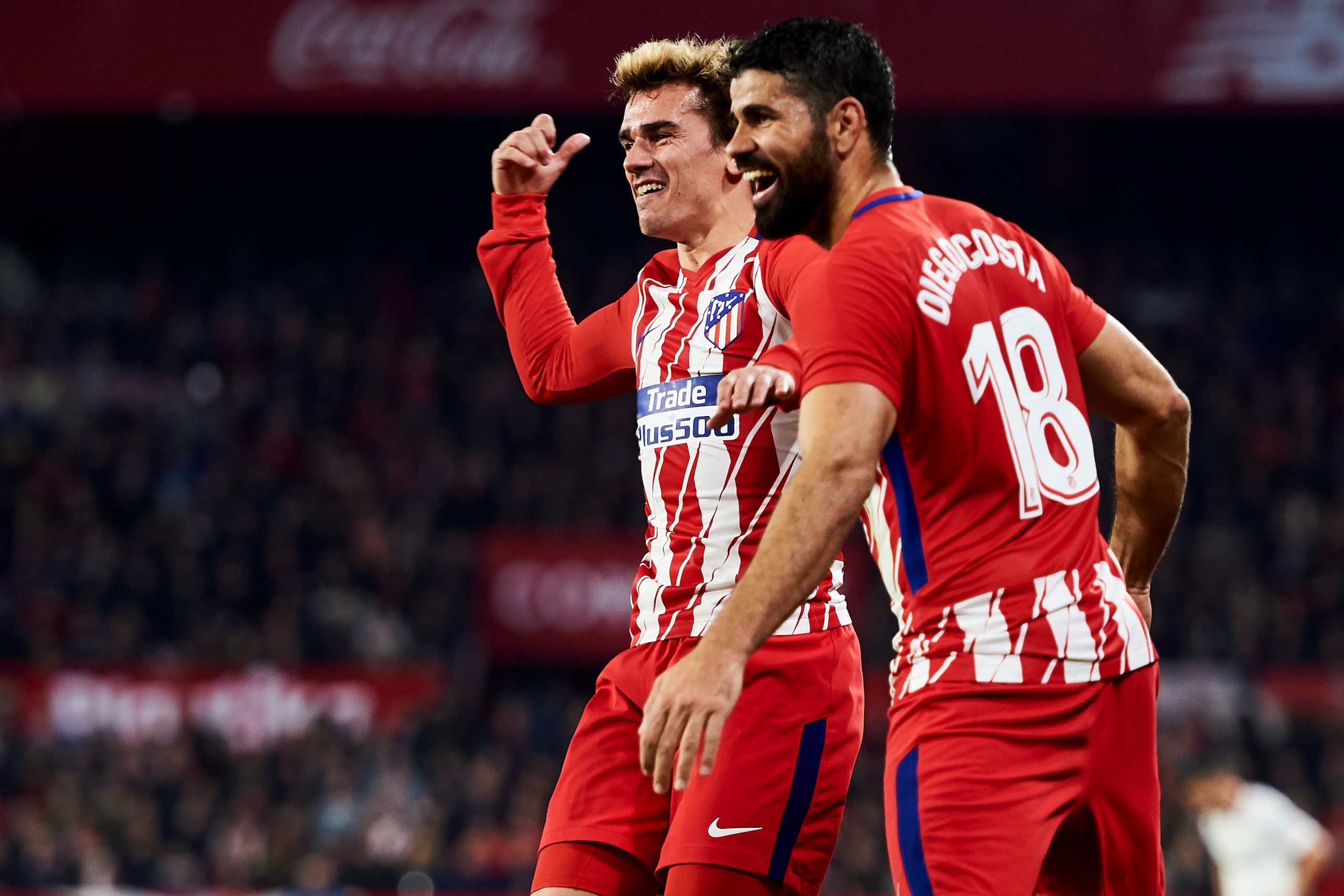 SEVILLE, SPAIN - FEBRUARY 25:  Antoine Griezmann and Diego Costa of Atletico Madrid celebrates after his team-mate Jorge Resurreccion 'Koke' scoring his team's fourth goal during the La Liga match between Sevilla CF and Atletico Madrid at Estadio Ramon Sa