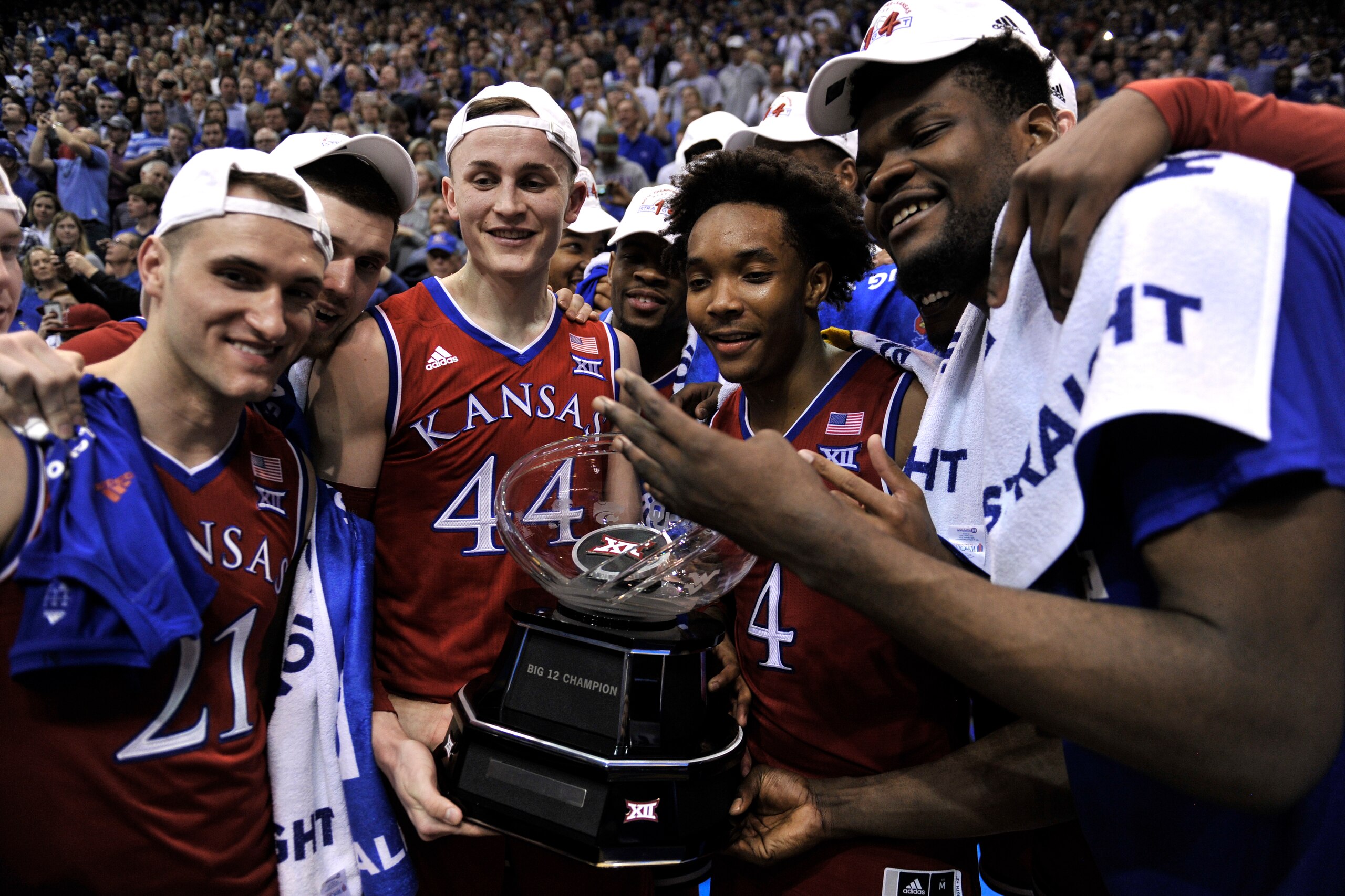 LAWRENCE, KS - FEBRUARY 26: Clay Young #21, Sviatoslav Mykhailiuk #10, Mitch Lightfoot #44, Devonte' Graham #4 and Udoka Azubuike #35 of the Kansas Jayhawks celebrate with the Big 12 Conference Trophy after their 80-70 win over the Texas Longhorns at Alle